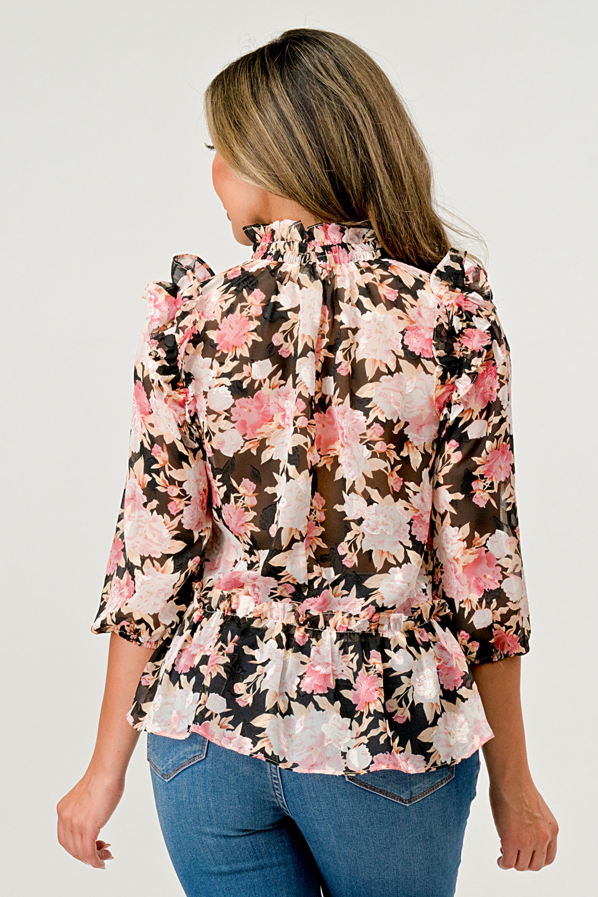 Floral High-Neck Ruffle Blouse featuring ruffle details and a hi-low design in floral chiffon fabric.