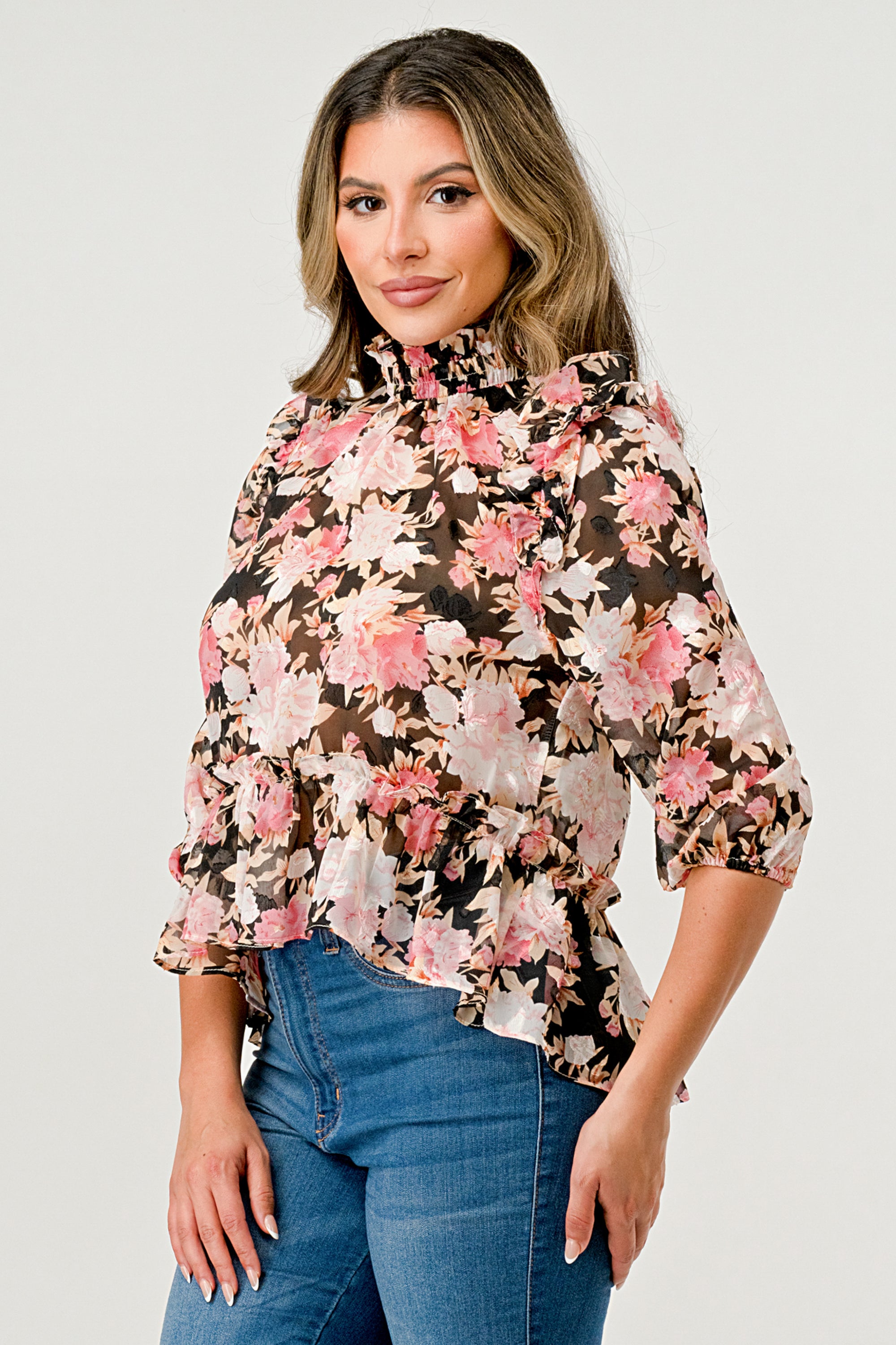 Floral High-Neck Ruffle Blouse featuring ruffle details and a hi-low design in floral chiffon fabric.