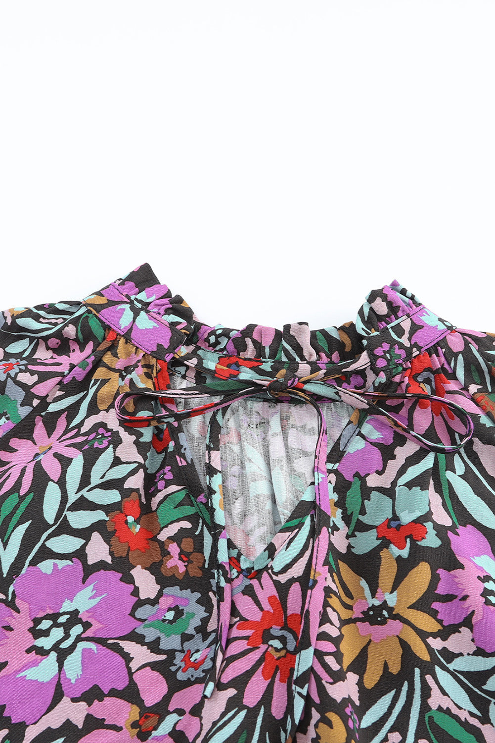 Floral Print Ruffled Long Sleeve V-Neck Blouse featuring a vibrant floral pattern and elegant ruffled details.