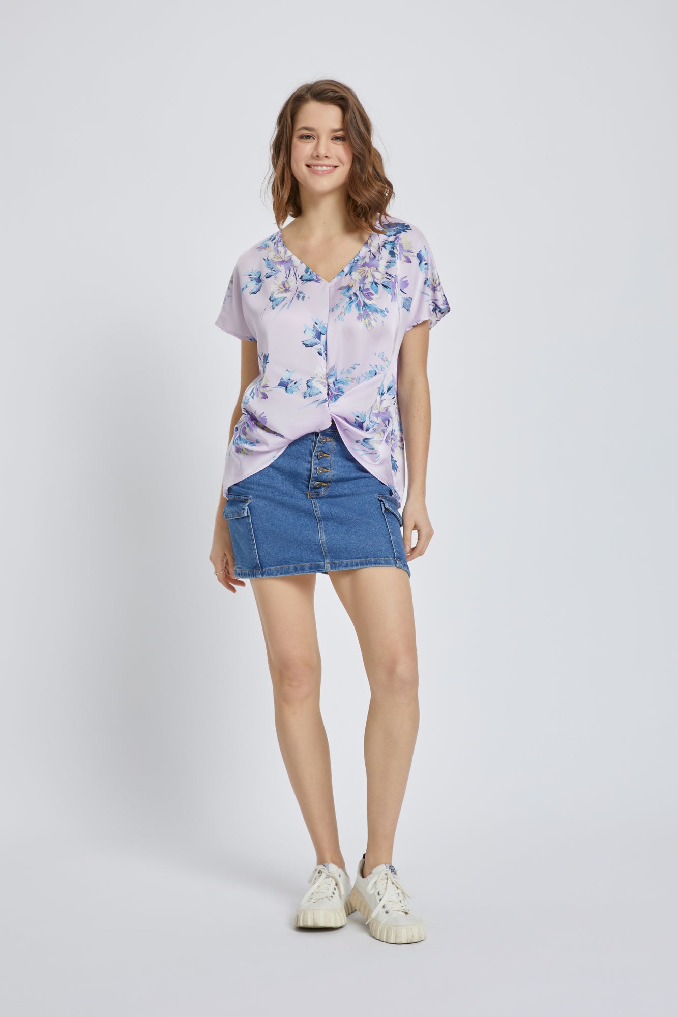Floral V-Neck Knot-Front Blouse featuring short dolman sleeves and a stylish knot detail in a vibrant floral satin fabric.