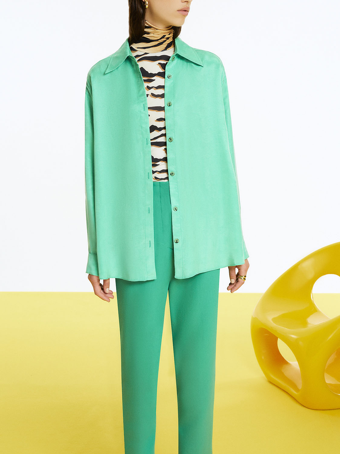 Flowy oversized shirt featuring a lapel collar, front buttons, and long sleeves with buttoned cuffs, designed for comfort and style.