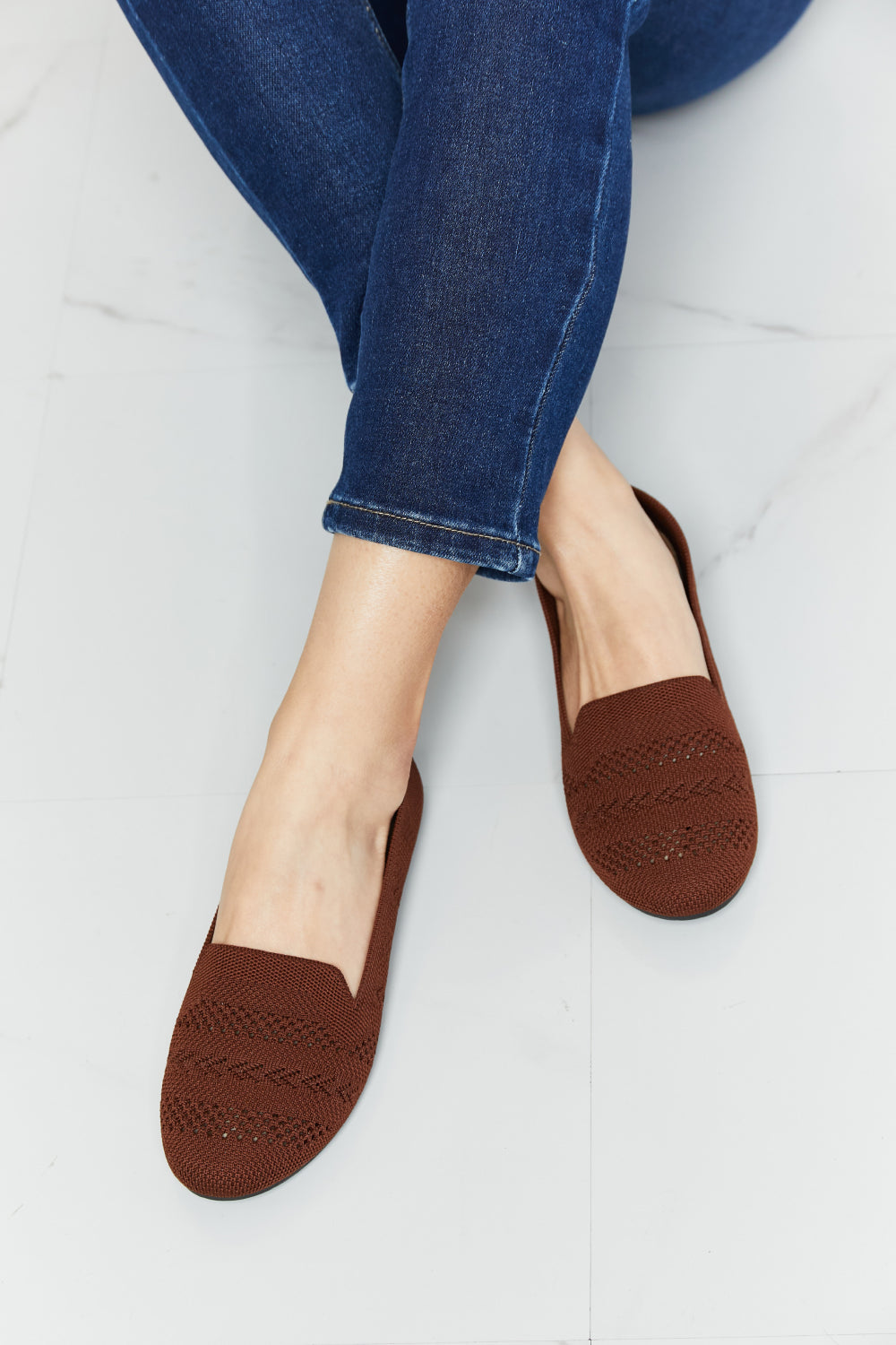 A pair of Forever Link Knit Flats in a flat lay style, showcasing their soft knit fabric and round toe design.
