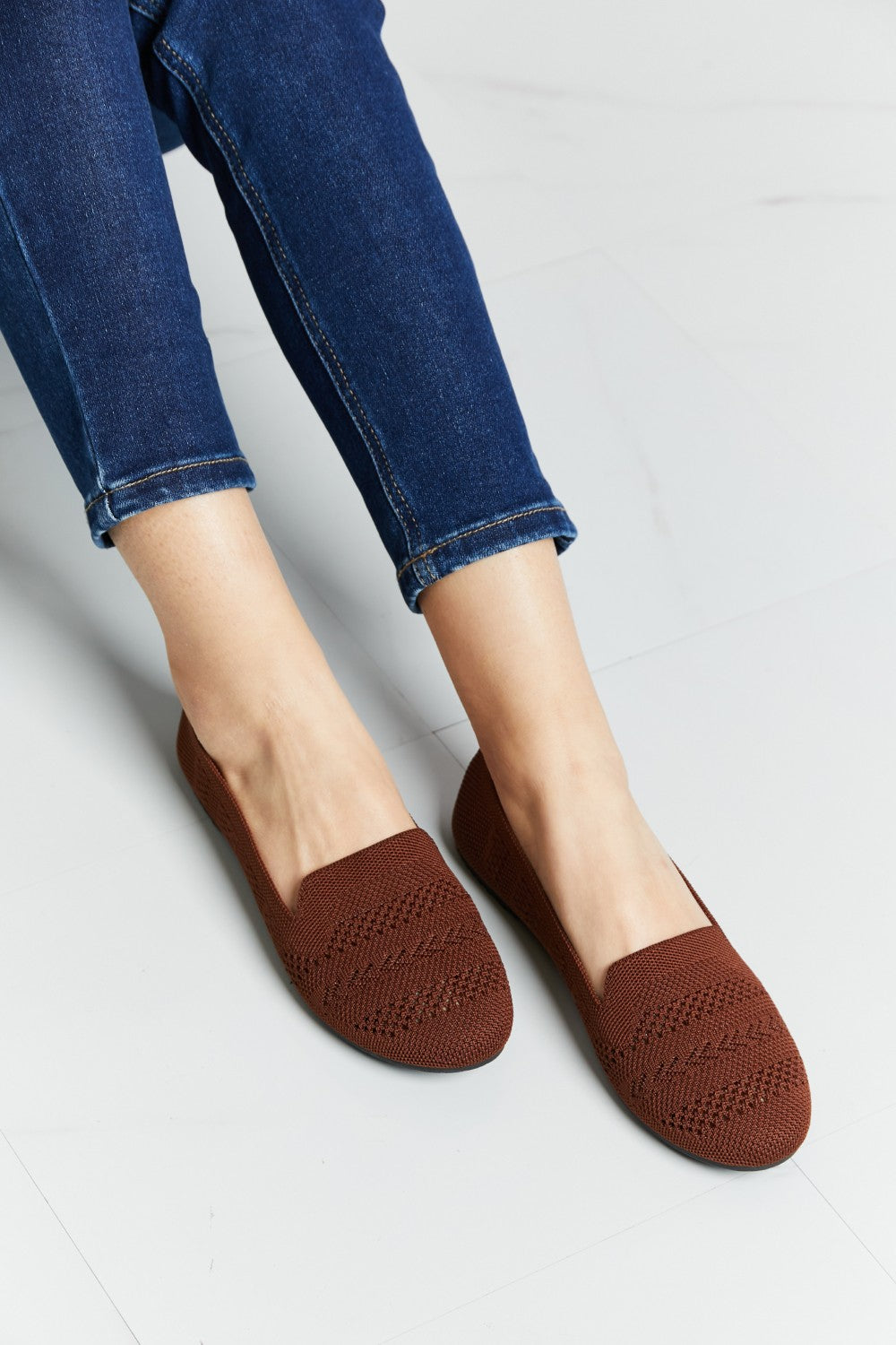 A pair of Forever Link Knit Flats in a flat lay style, showcasing their soft knit fabric and round toe design.