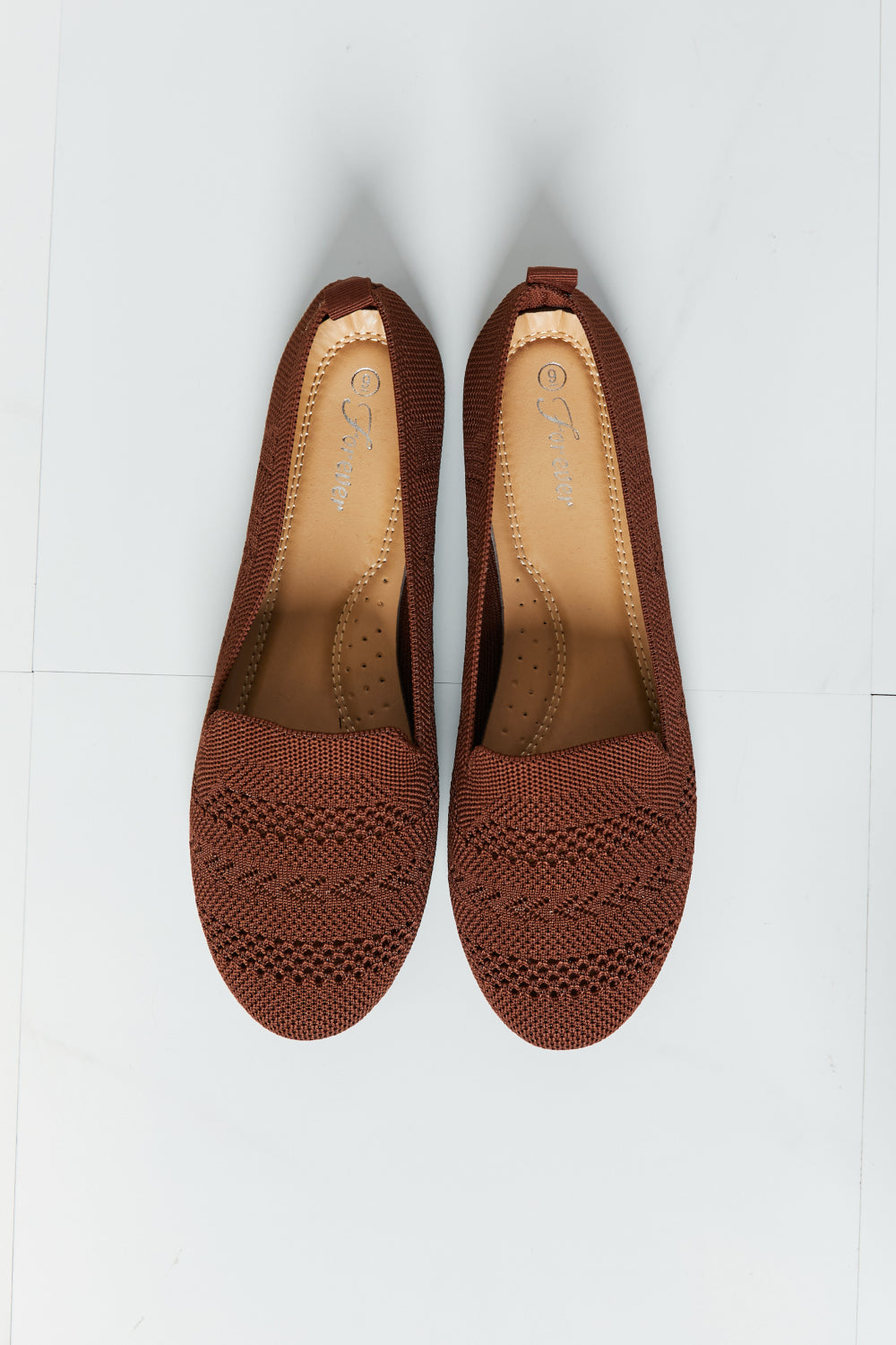 A pair of Forever Link Knit Flats in a flat lay style, showcasing their soft knit fabric and round toe design.