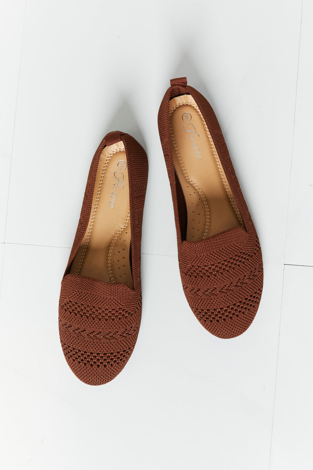 A pair of Forever Link Knit Flats in a flat lay style, showcasing their soft knit fabric and round toe design.
