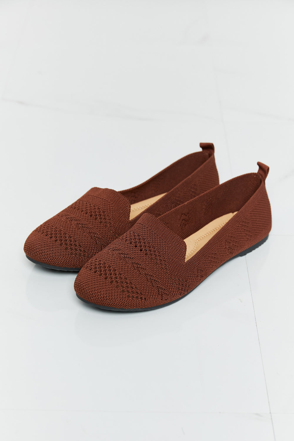 A pair of Forever Link Knit Flats in a flat lay style, showcasing their soft knit fabric and round toe design.