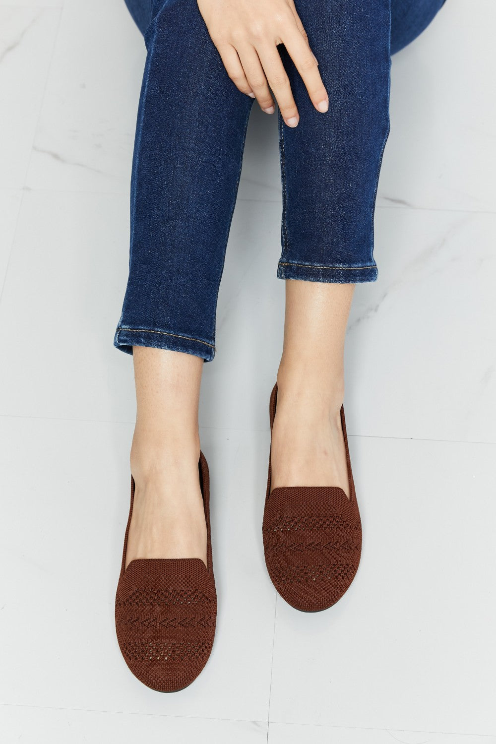 A pair of Forever Link Knit Flats in a flat lay style, showcasing their soft knit fabric and round toe design.