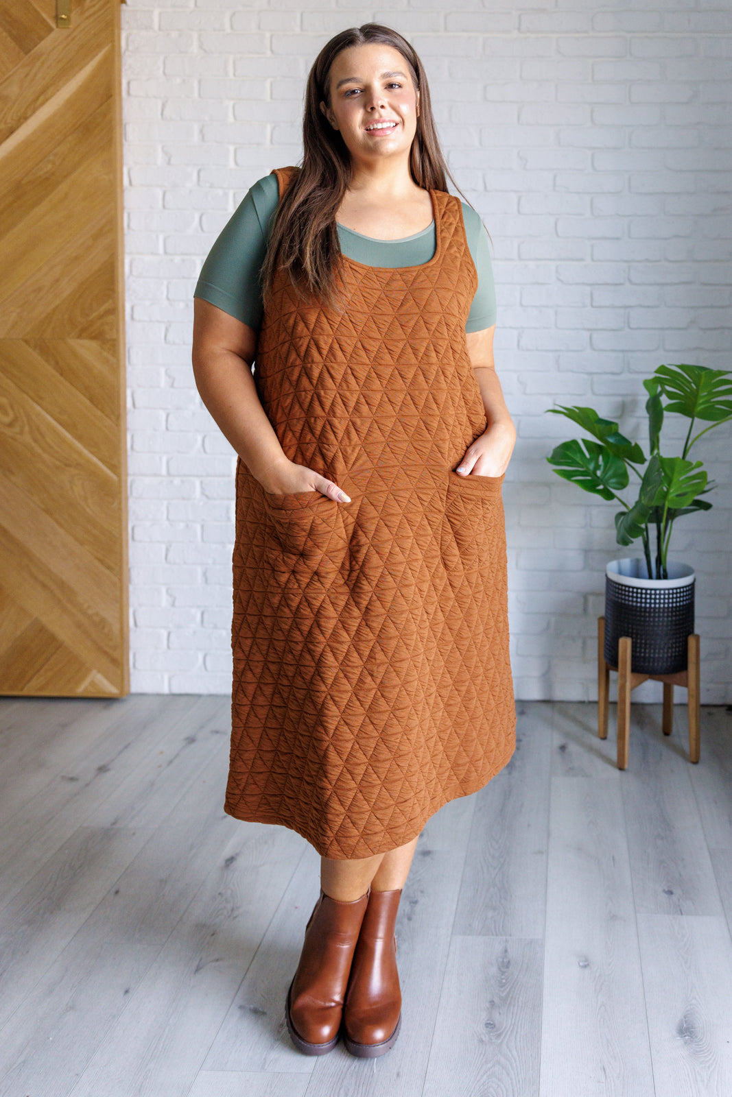 A stylish Free Falling Quilted Midi Dress featuring a scoop neckline, front pockets, and a cozy quilted fabric, perfect for layering.