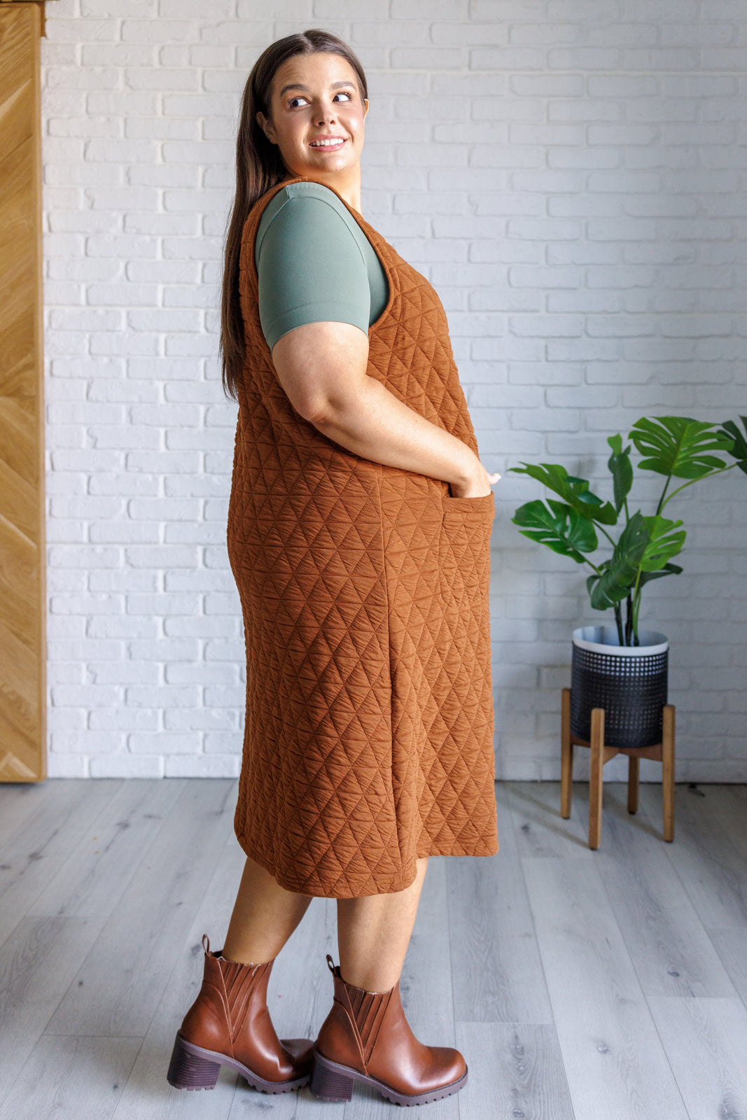 A stylish Free Falling Quilted Midi Dress featuring a scoop neckline, front pockets, and a cozy quilted fabric, perfect for layering.