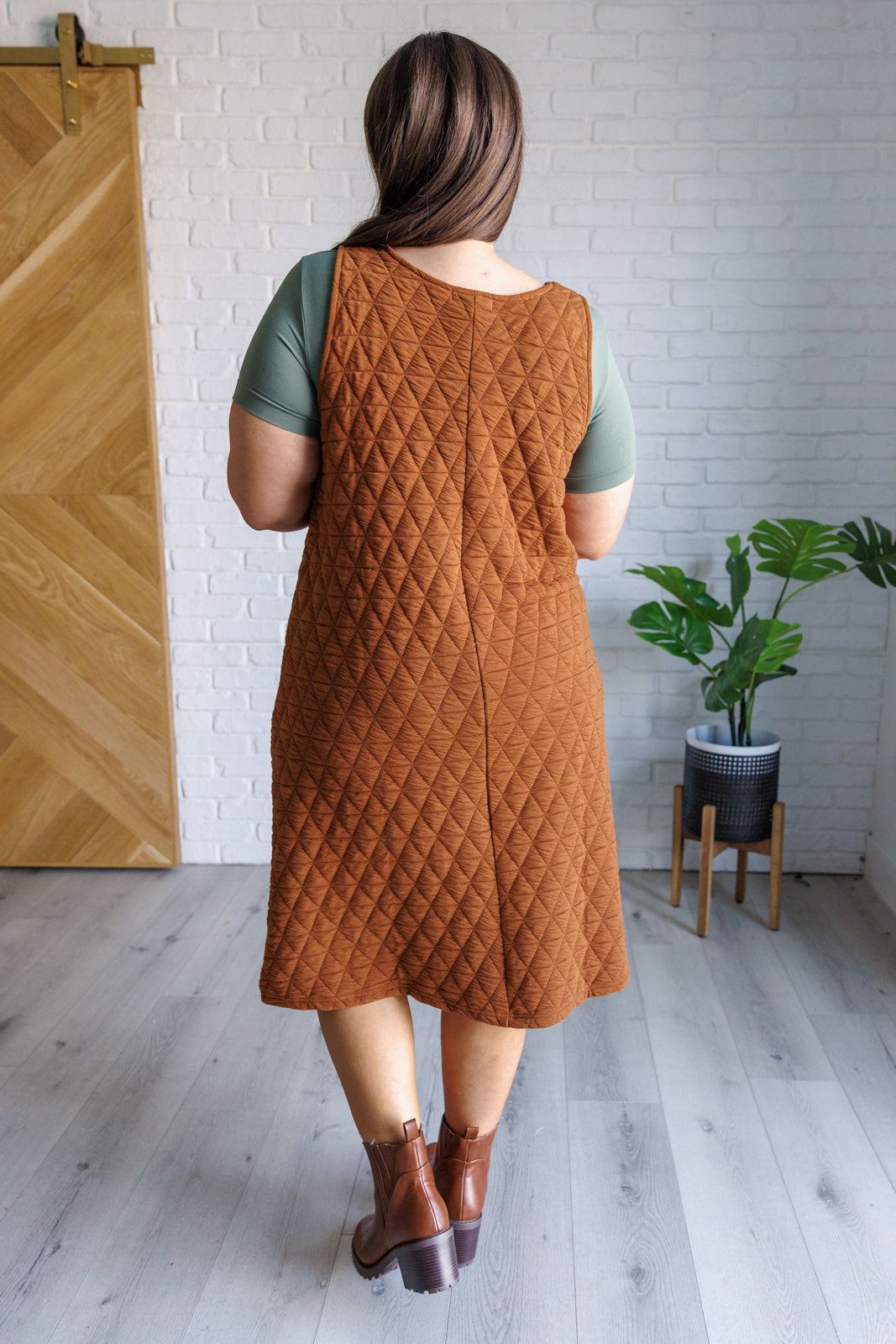 A stylish Free Falling Quilted Midi Dress featuring a scoop neckline, front pockets, and a cozy quilted fabric, perfect for layering.