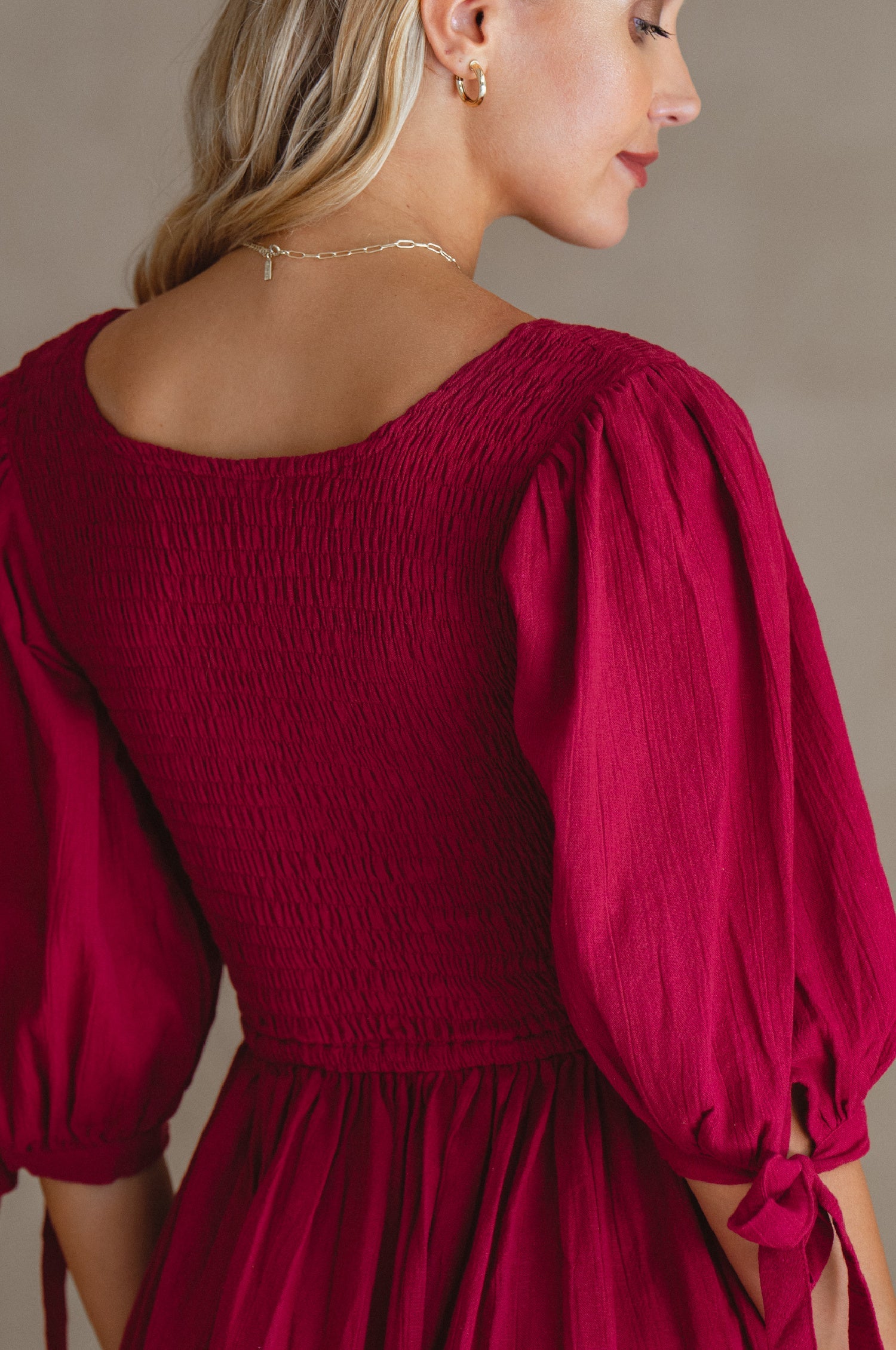 Freya Smocked Linen Midi Dress featuring a smocked bodice and tie-up puffy sleeves in a beautiful crinkle linen fabric.