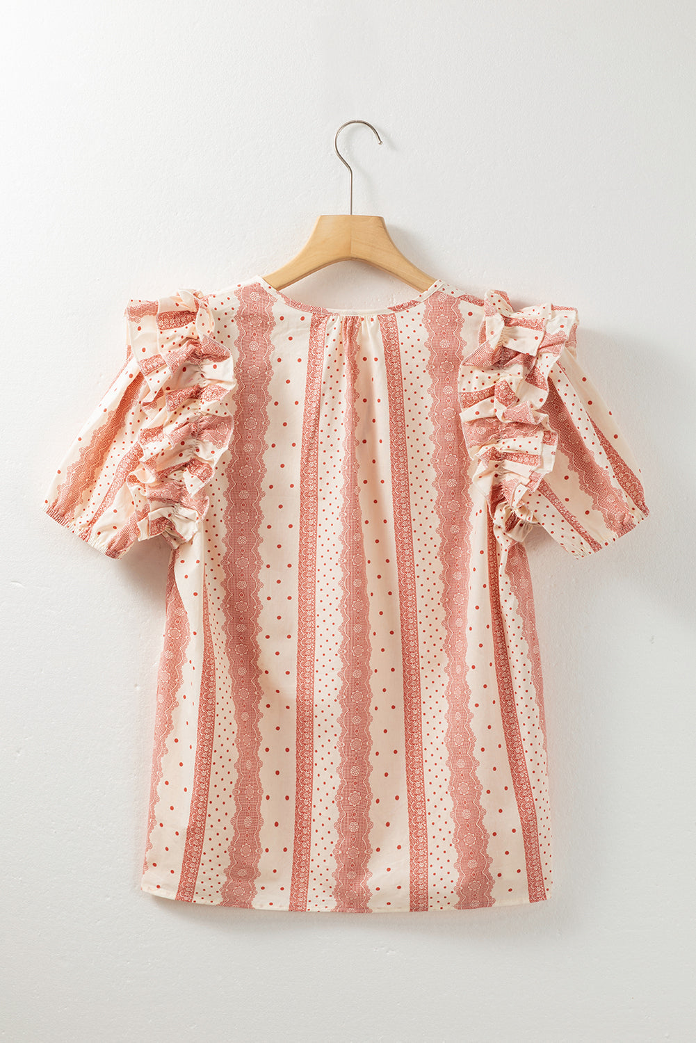 A stylish red blouse featuring frilled short puff sleeves and a mixed polka dot print, perfect for casual and formal occasions.