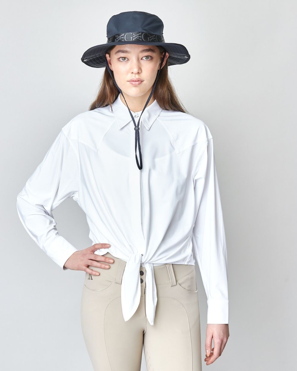 Front Tie Riding Shirt in White, featuring a self-tie front and modern equestrian design, made from soft Italian fabric.