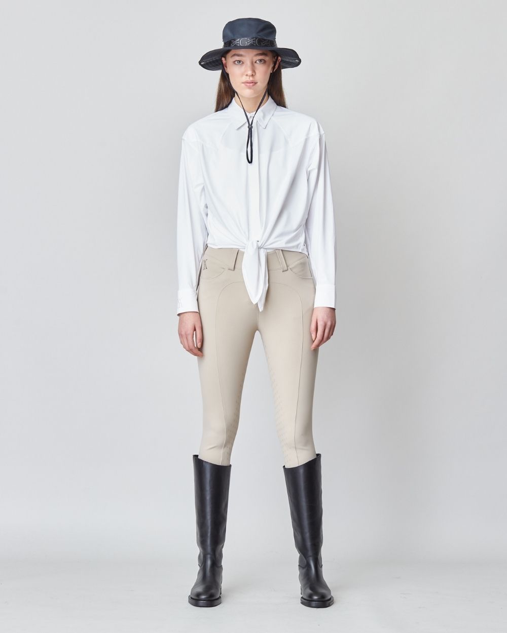 Front Tie Riding Shirt in White, featuring a self-tie front and modern equestrian design, made from soft Italian fabric.