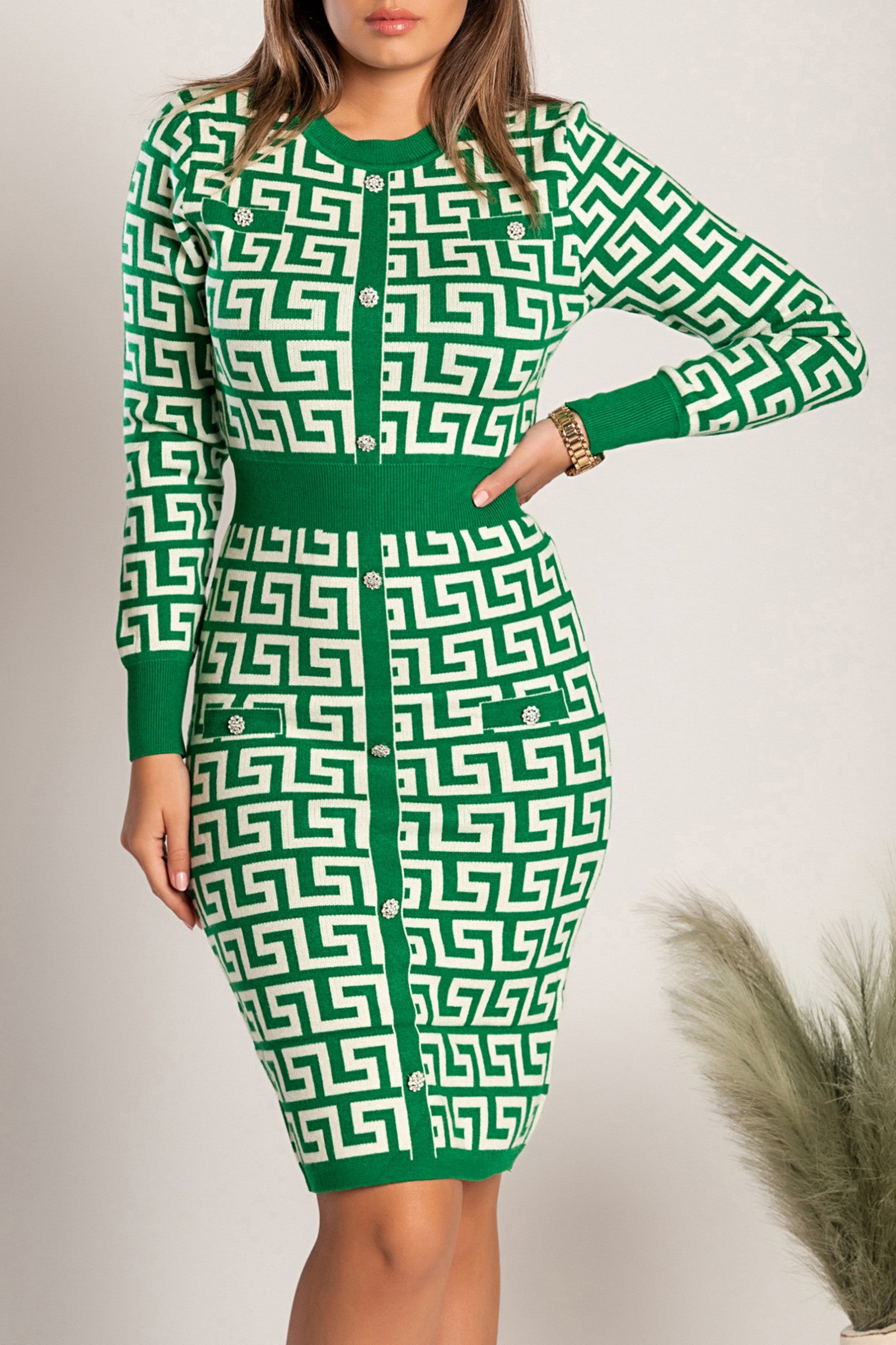 Green geometric print knitted mini dress Geya with long sleeves and decorative buttons, showcasing a fitted silhouette.