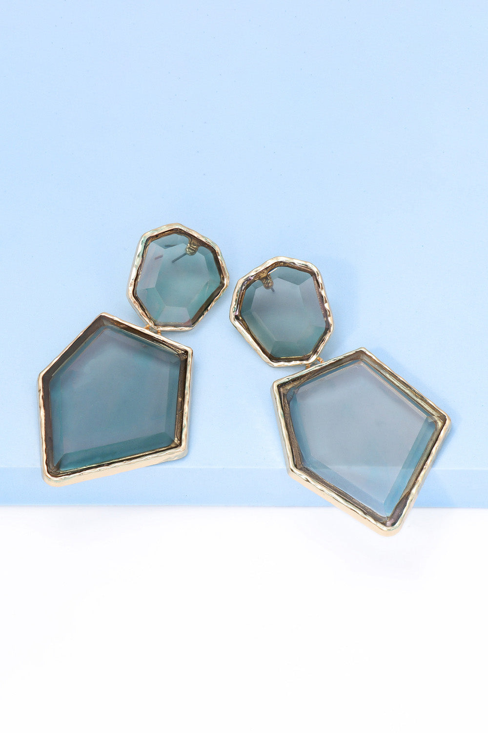 Geometrical shape dangle earrings made of zinc alloy and resin, showcasing a modern design with a unique frame.