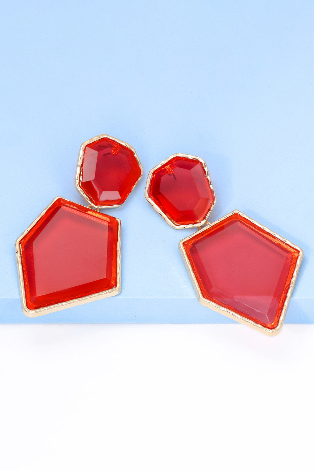 Geometrical shape dangle earrings made of zinc alloy and resin, showcasing a modern design with a unique frame.