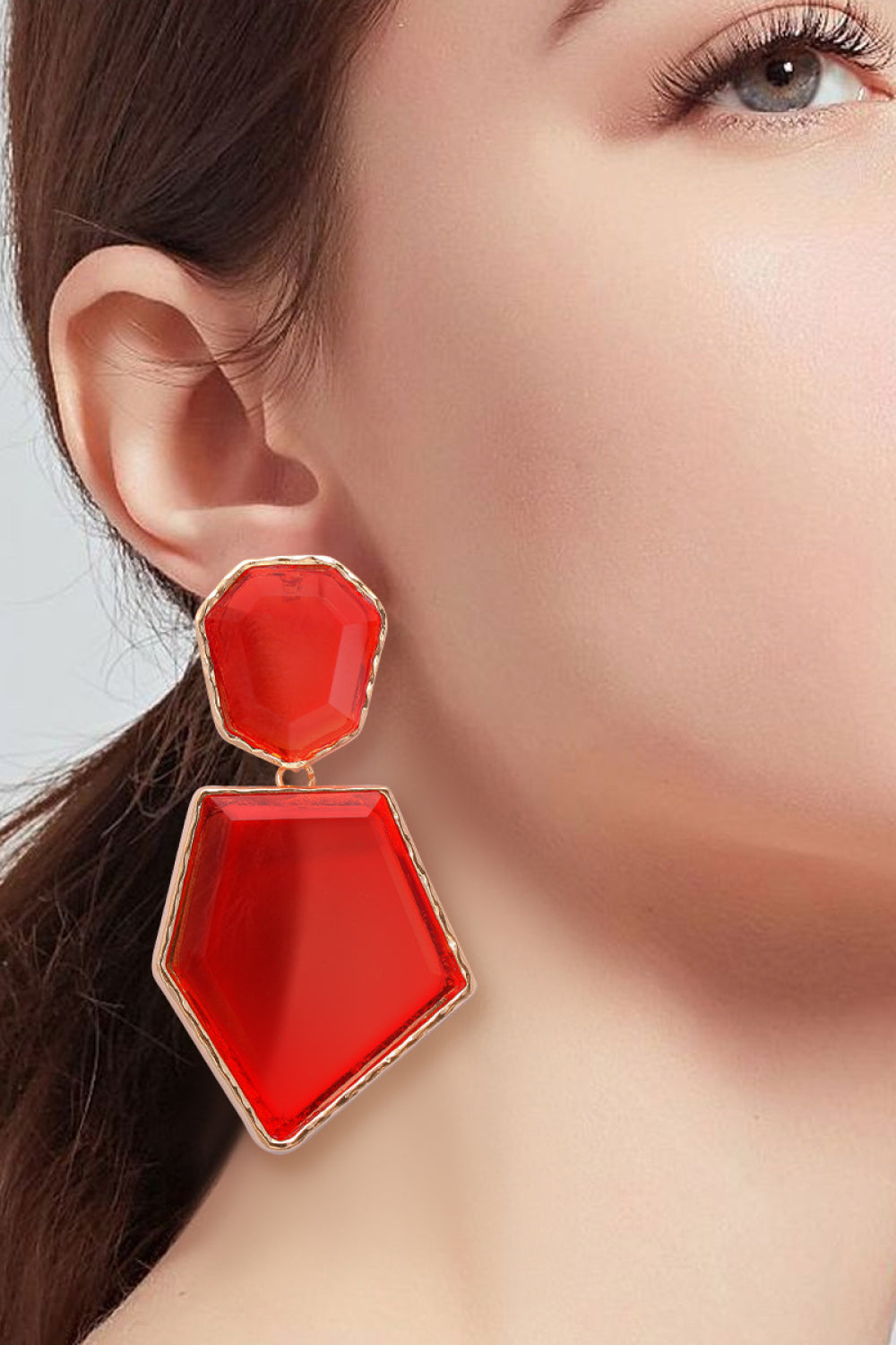 Geometrical shape dangle earrings made of zinc alloy and resin, showcasing a modern design with a unique frame.