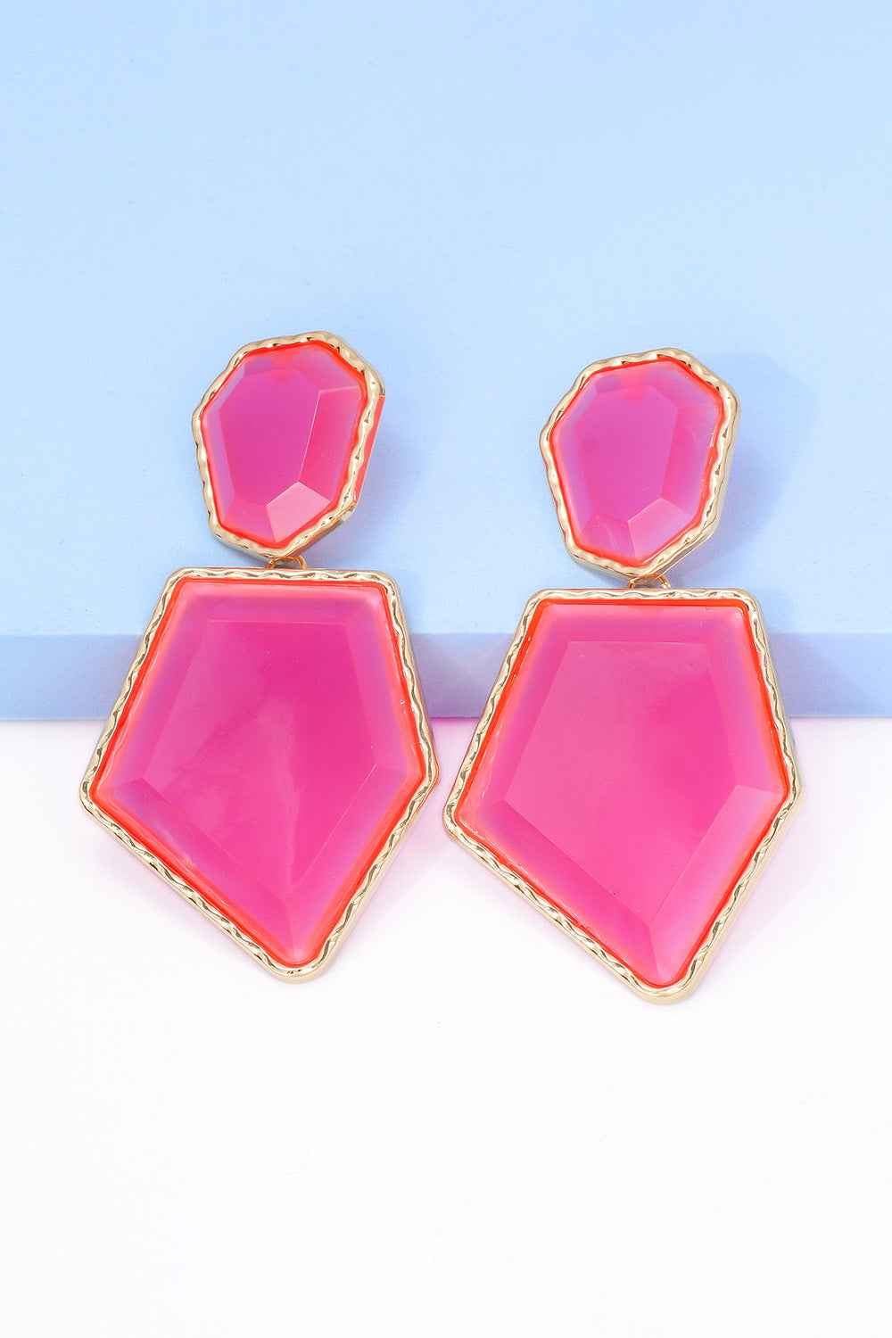 Geometrical shape dangle earrings made of zinc alloy and resin, showcasing a modern design with a unique frame.
