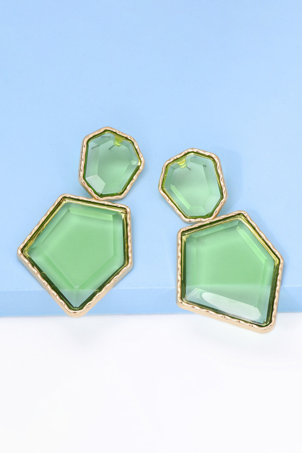 Geometrical shape dangle earrings made of zinc alloy and resin, showcasing a modern design with a unique frame.