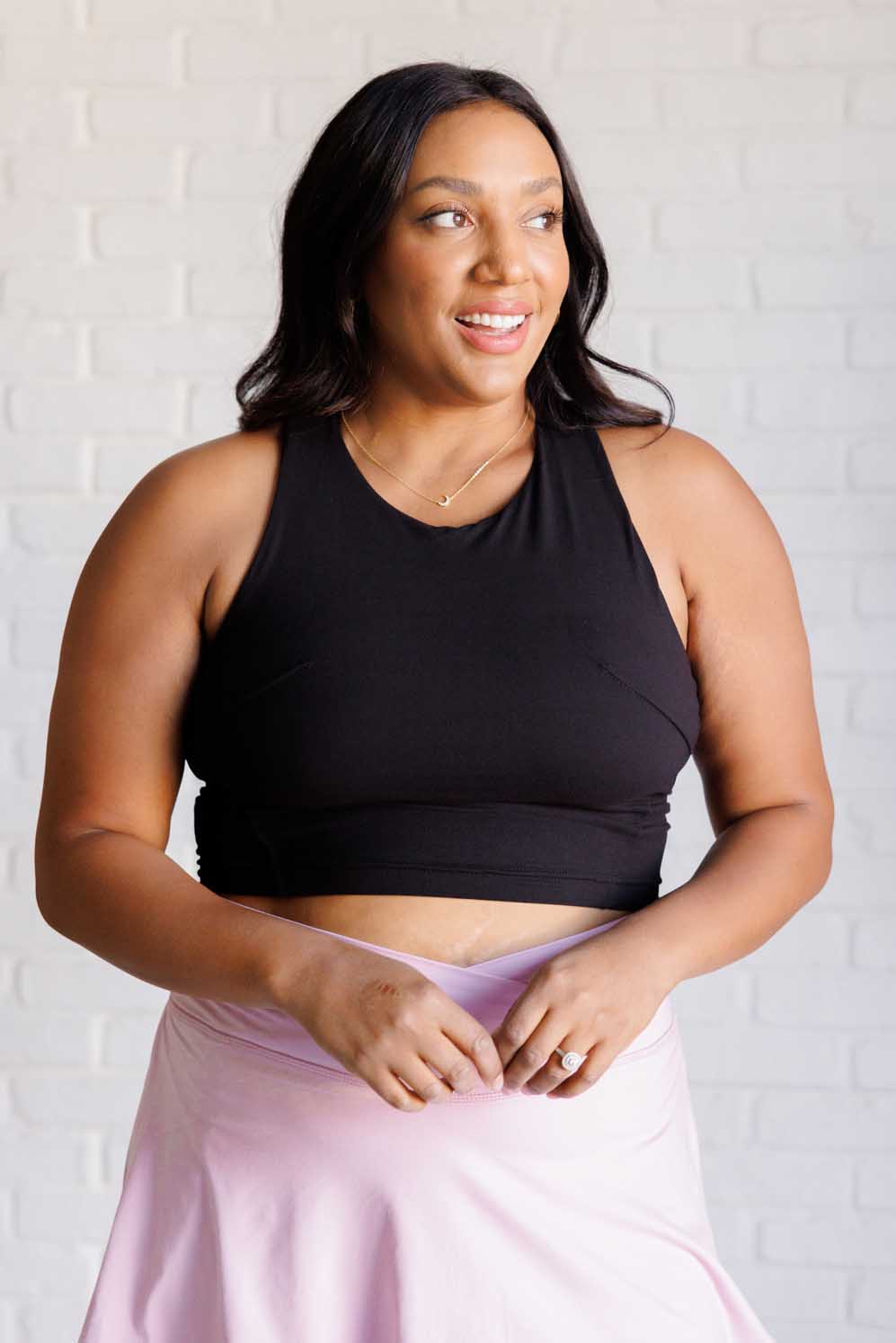 Get Moving Racer Back Crop Tank in soft fabric with contour seams, featuring removable cups and a stylish racerback design.