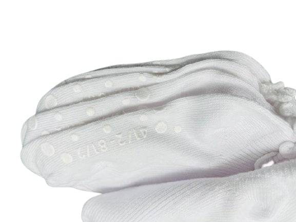 Girls Non-Skid Seamless Toe Socks in white with pink and white ruffle edges, showcasing a soft cotton material and non-skid dots on the bottom.