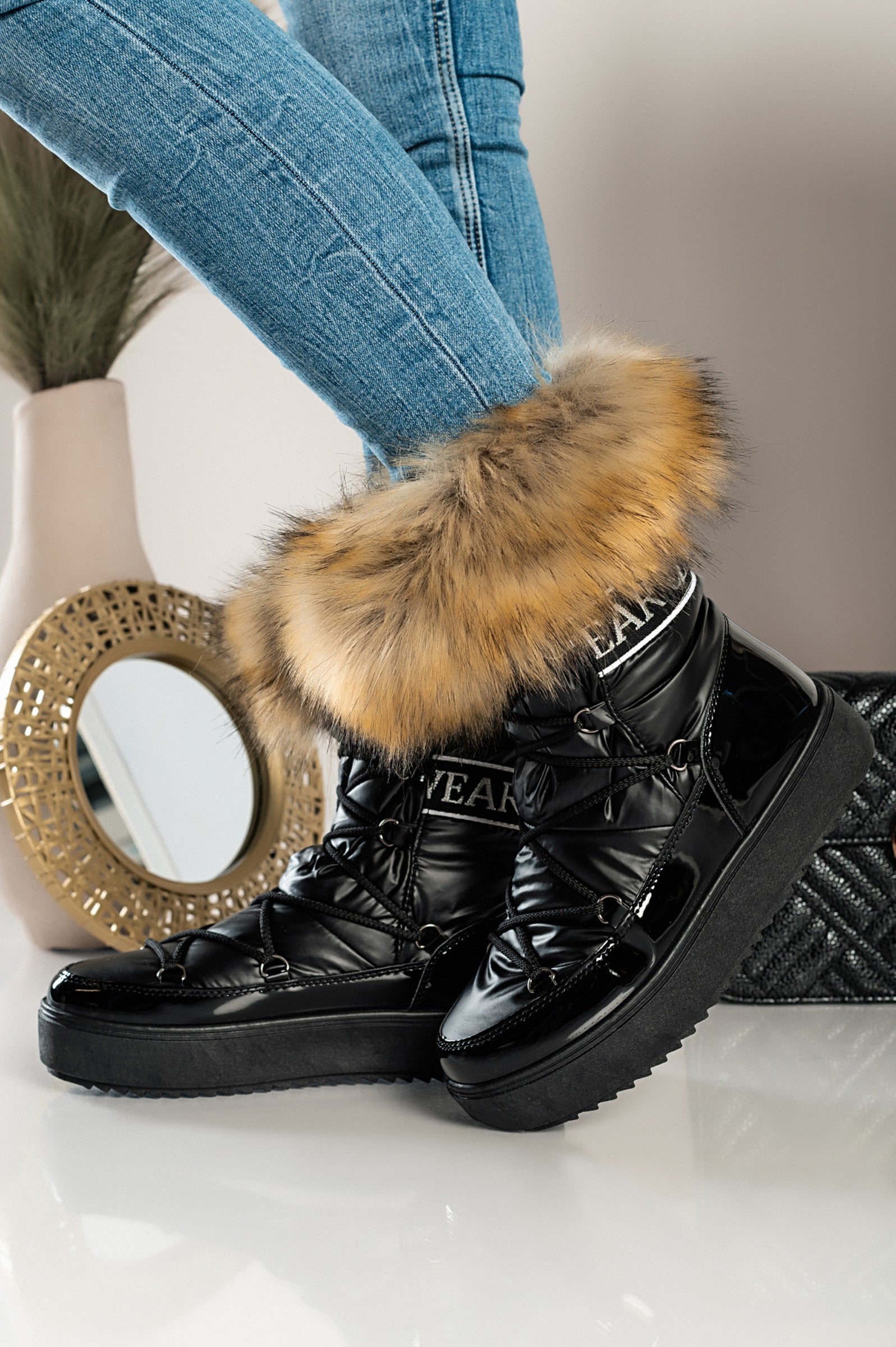 Elegantni črni gležnarji z umetnim krznom Sutera, z dvignjenim podplatom in okroglo konico, zavezani z vezalkami.