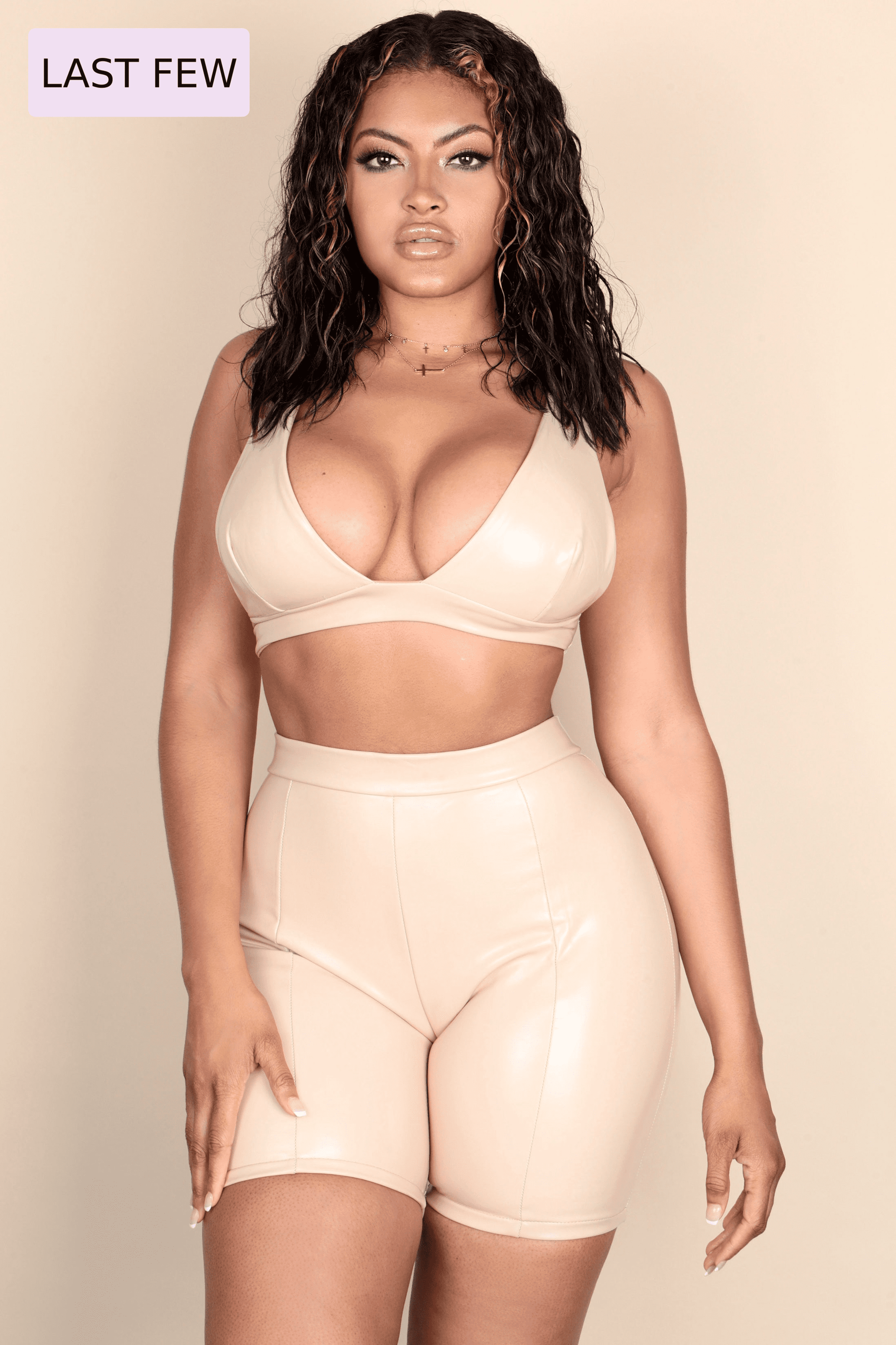 GOT IT BAD nude vegan leather crop top and biker shorts set, featuring a deep-V neckline and adjustable straps, perfect for stylish outings.