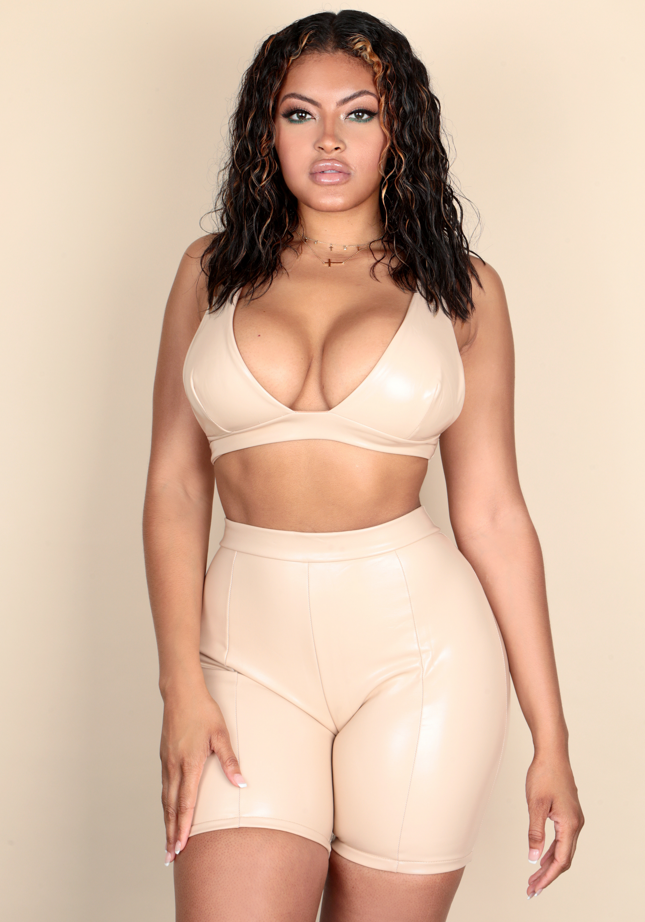 GOT IT BAD nude vegan leather crop top and biker shorts set, featuring a deep-V neckline and adjustable straps, perfect for stylish outings.