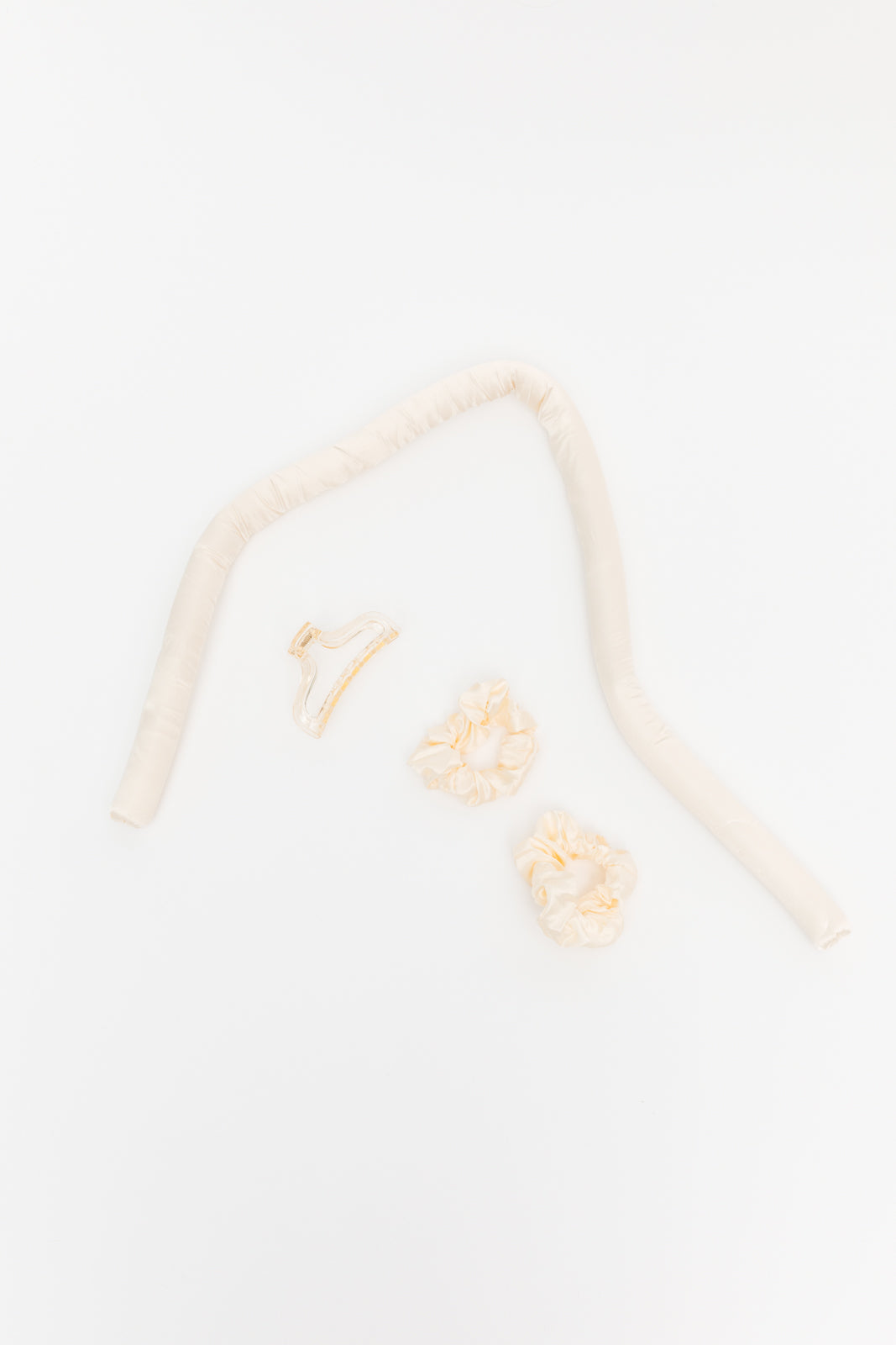 Got Your Back Heatless Curling Set in Champagne featuring a rubber filled curling headband, two scrunchies, and a hair clip.