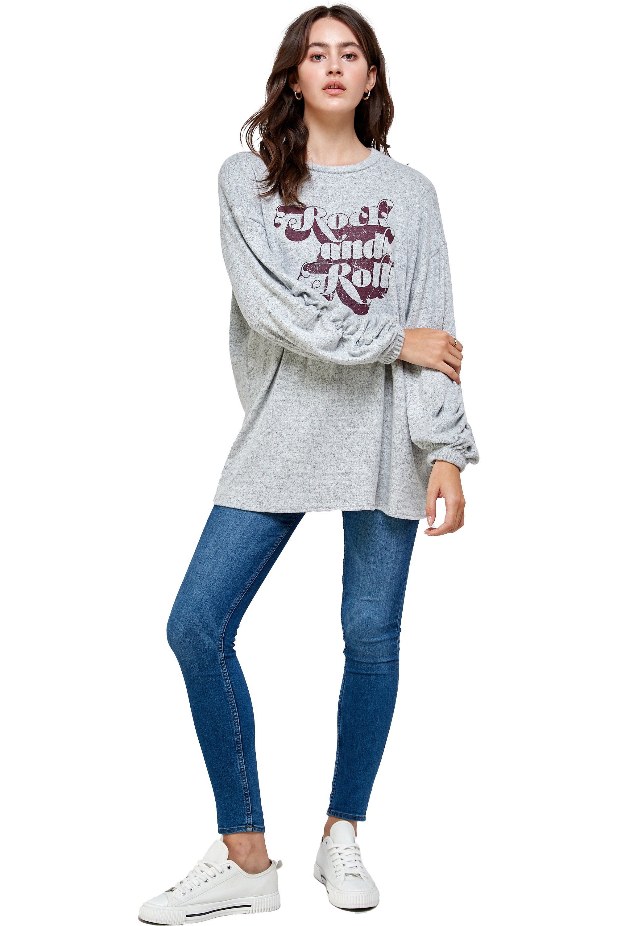 Brushed knit loose fit sweatshirt with trendy screen print design, modeled by a woman standing at 5'-8" wearing size Small.