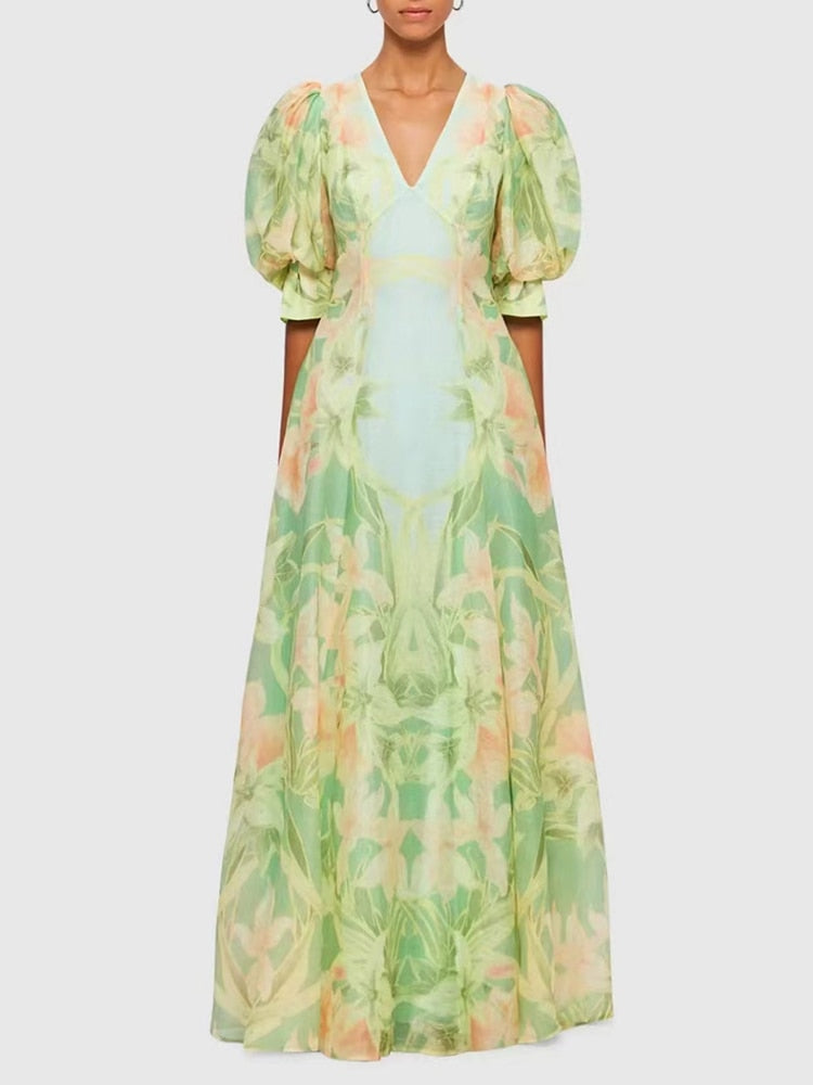 A stylish green printing V neck dress with short puff sleeves and high waist folds, perfect for summer occasions.