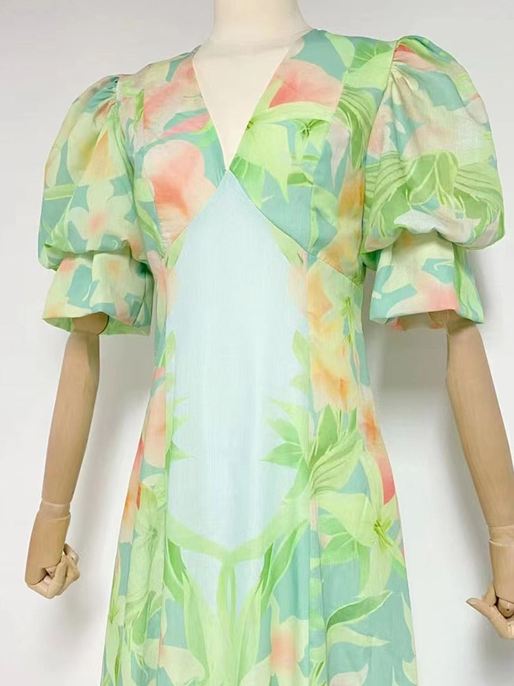 A stylish green printing V neck dress with short puff sleeves and high waist folds, perfect for summer occasions.
