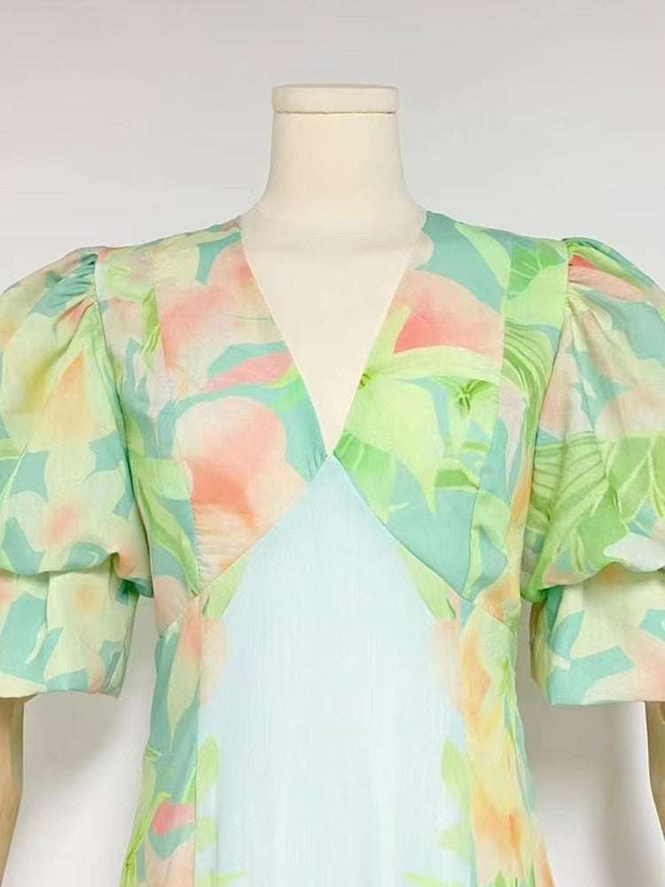 A stylish green printing V neck dress with short puff sleeves and high waist folds, perfect for summer occasions.