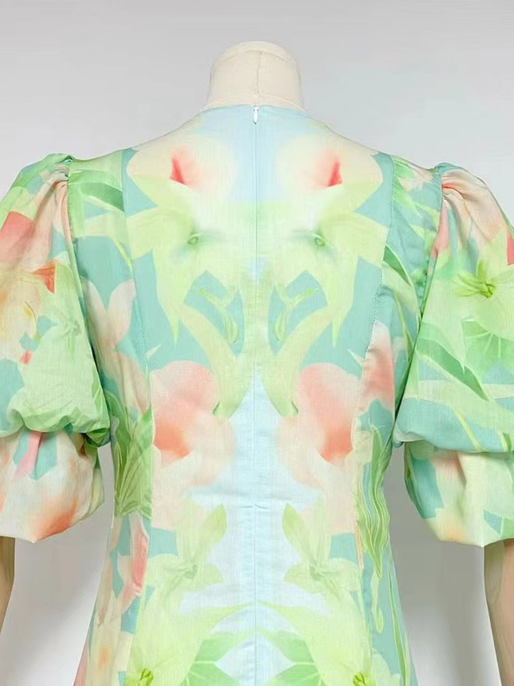 A stylish green printing V neck dress with short puff sleeves and high waist folds, perfect for summer occasions.