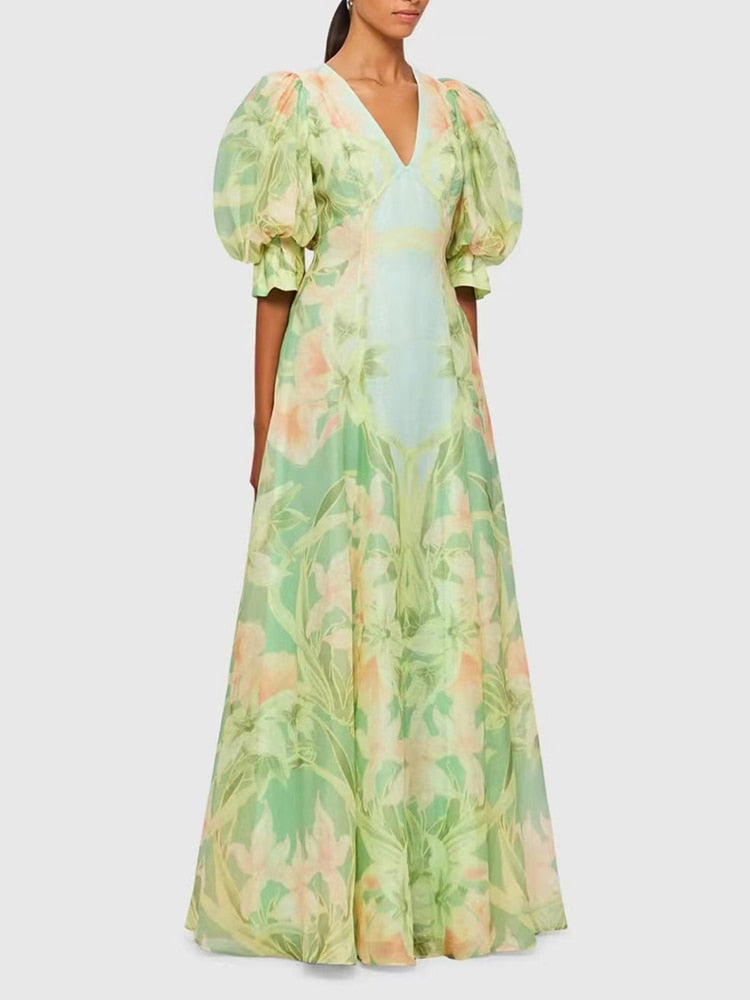 A stylish green printing V neck dress with short puff sleeves and high waist folds, perfect for summer occasions.