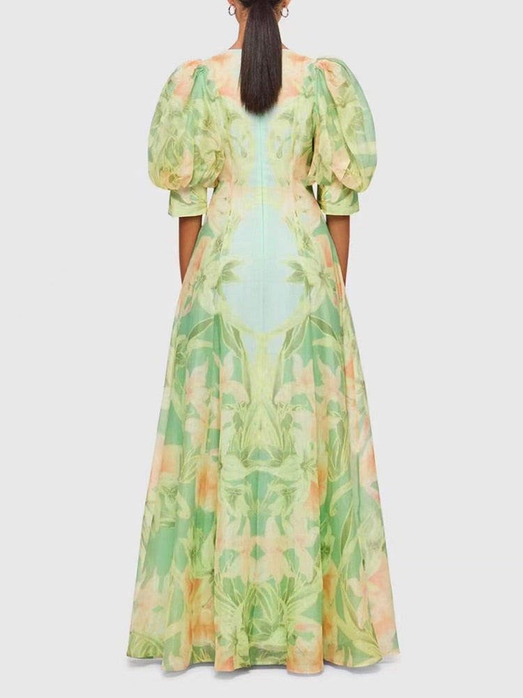 A stylish green printing V neck dress with short puff sleeves and high waist folds, perfect for summer occasions.