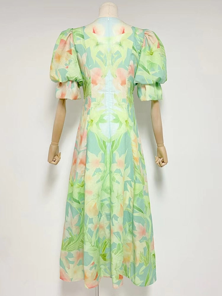 A stylish green printing V neck dress with short puff sleeves and high waist folds, perfect for summer occasions.