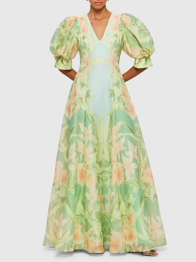 A stylish green printing V neck dress with short puff sleeves and high waist folds, perfect for summer occasions.