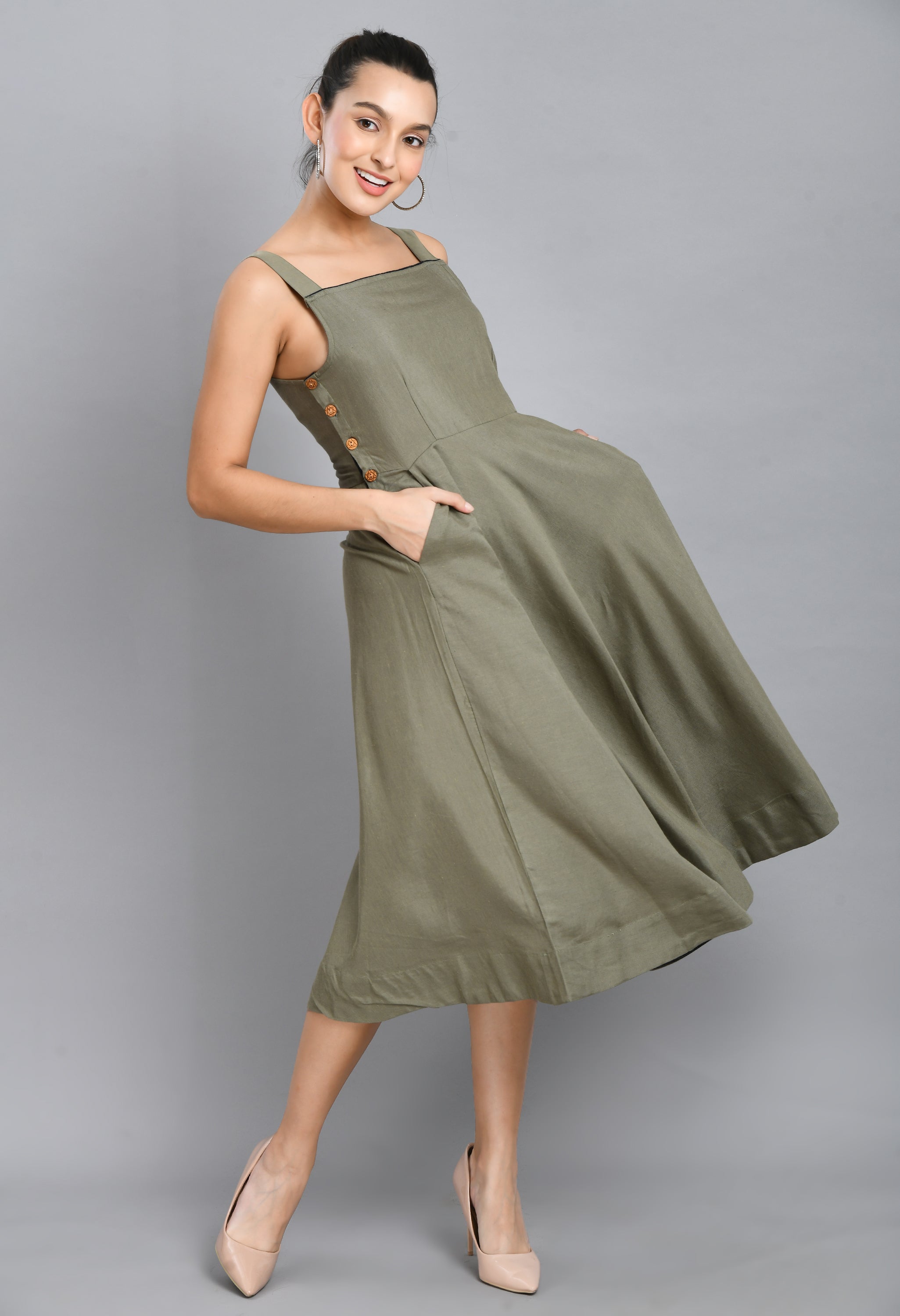 A stylish grey linen dress featuring wood buttons, sleeveless design, and an asymmetrical hem, perfect for casual occasions.