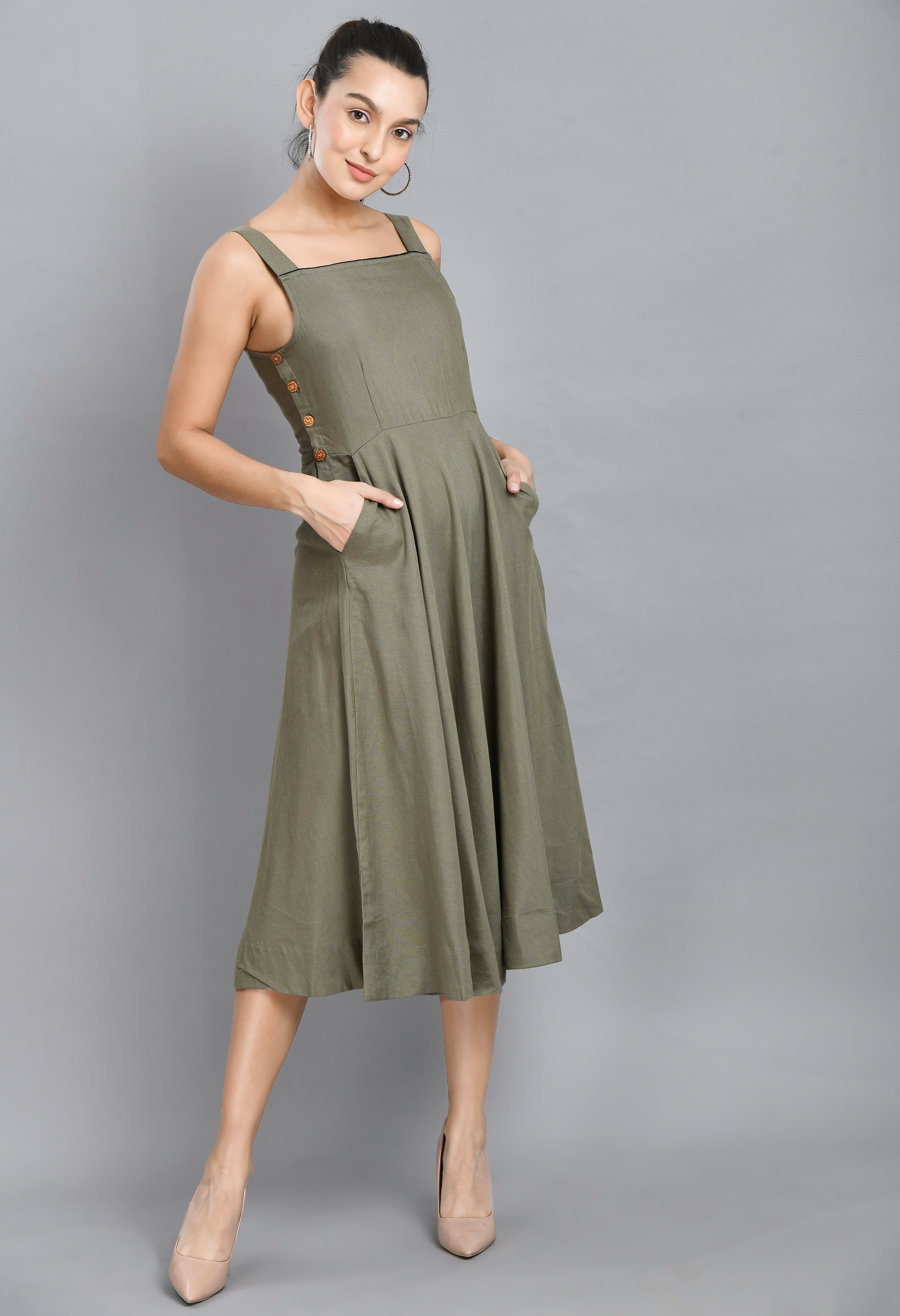A stylish grey linen dress featuring wood buttons, sleeveless design, and an asymmetrical hem, perfect for casual occasions.