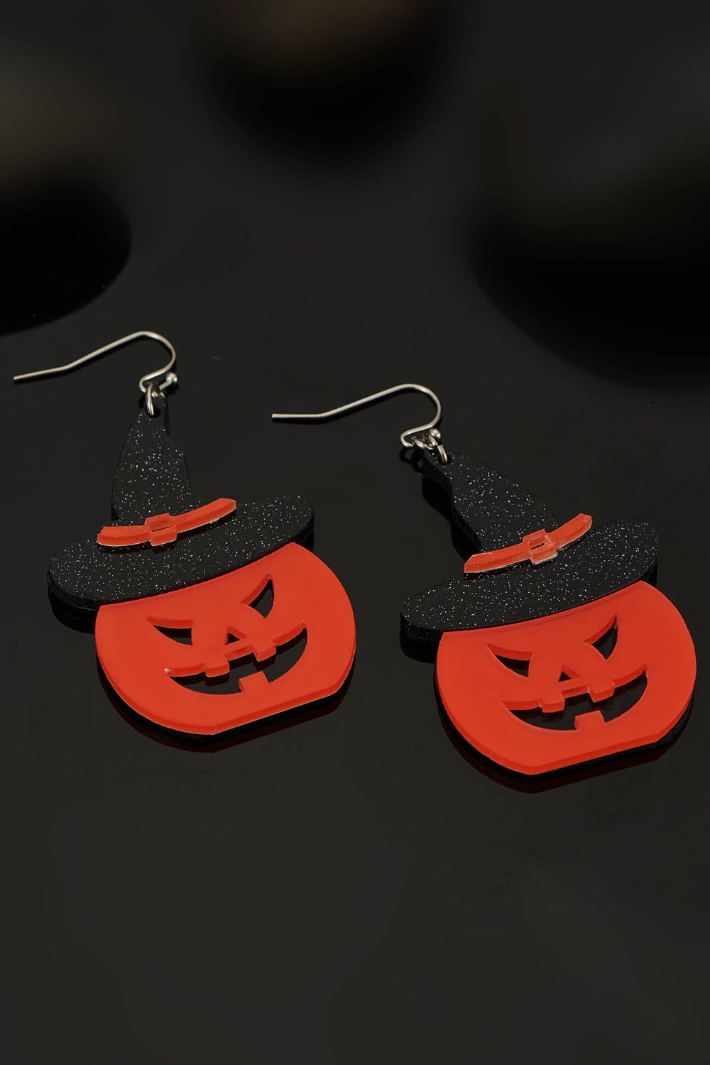 A pair of Halloween Jack-O-Lantern dangle earrings featuring a vibrant pumpkin design, made from lightweight alloy material.