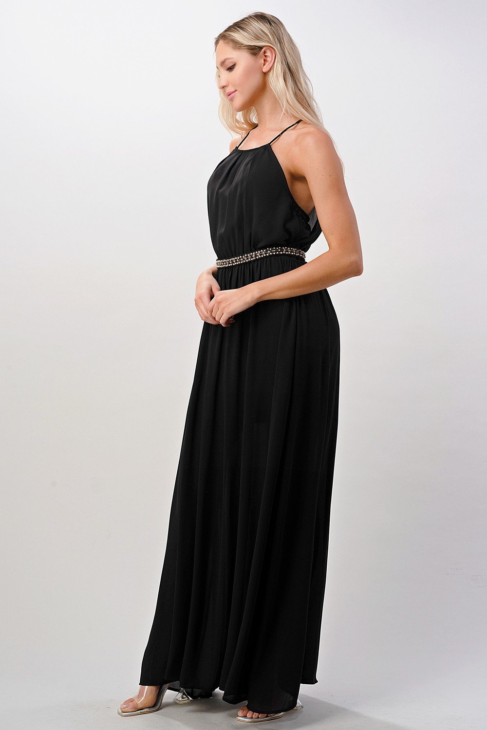 A beautiful model wearing a Pleated Cami Chiffon Maxi Dress, showcasing its elegant pleats and flowing design.