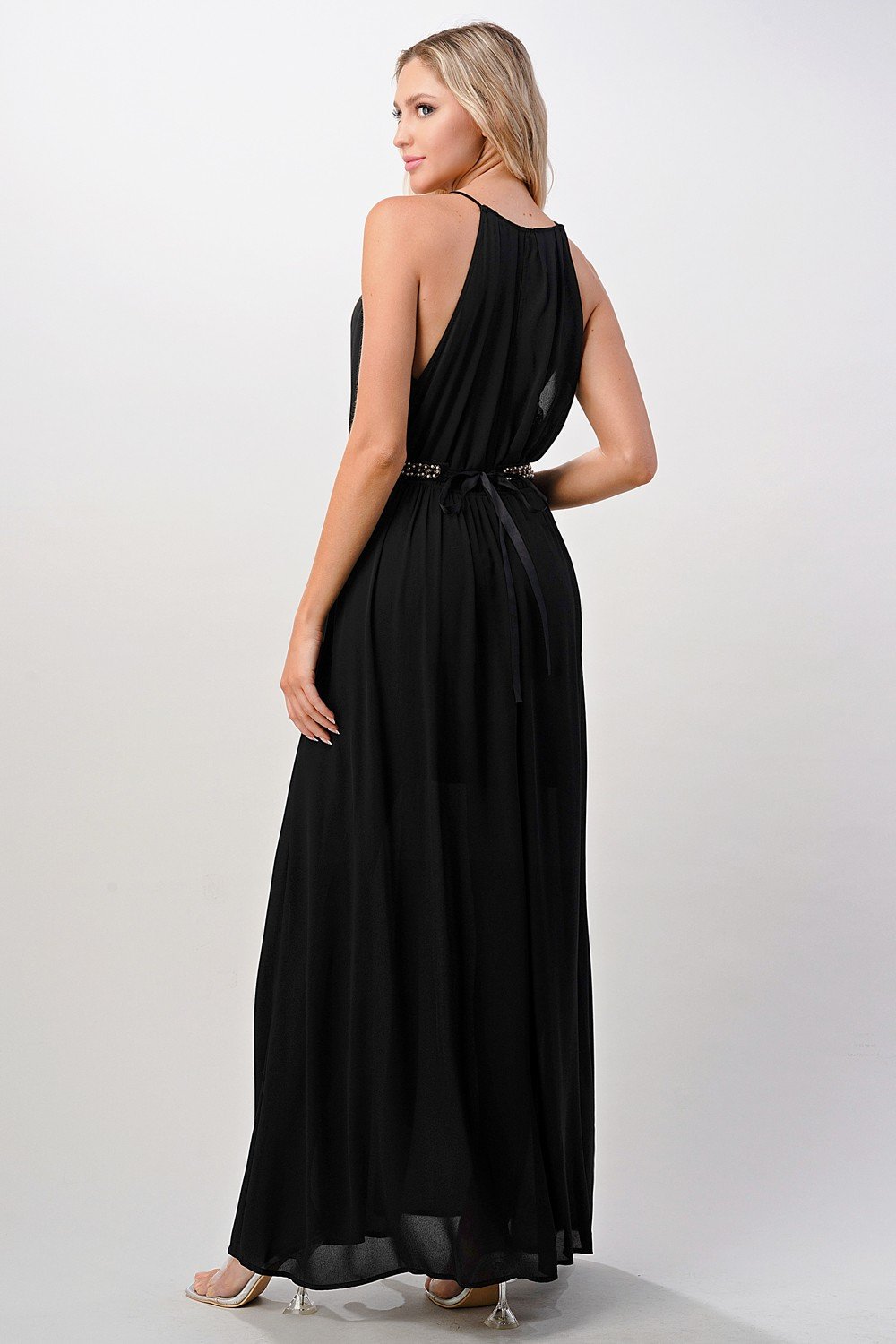 A beautiful model wearing a Pleated Cami Chiffon Maxi Dress, showcasing its elegant pleats and flowing design.