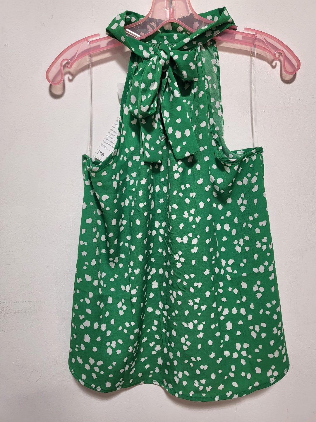 A stylish halter neck sleeveless top in satin featuring a vibrant abstract print, perfect for summer outings.