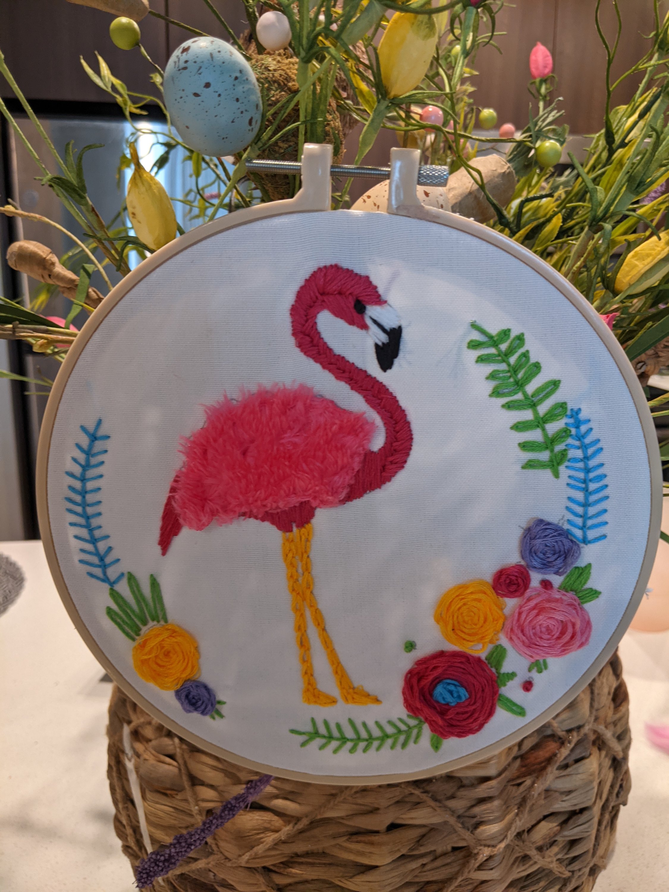 Hand embroidered flamingo hoop with vibrant colors, perfect for wall hanging or shelf display.