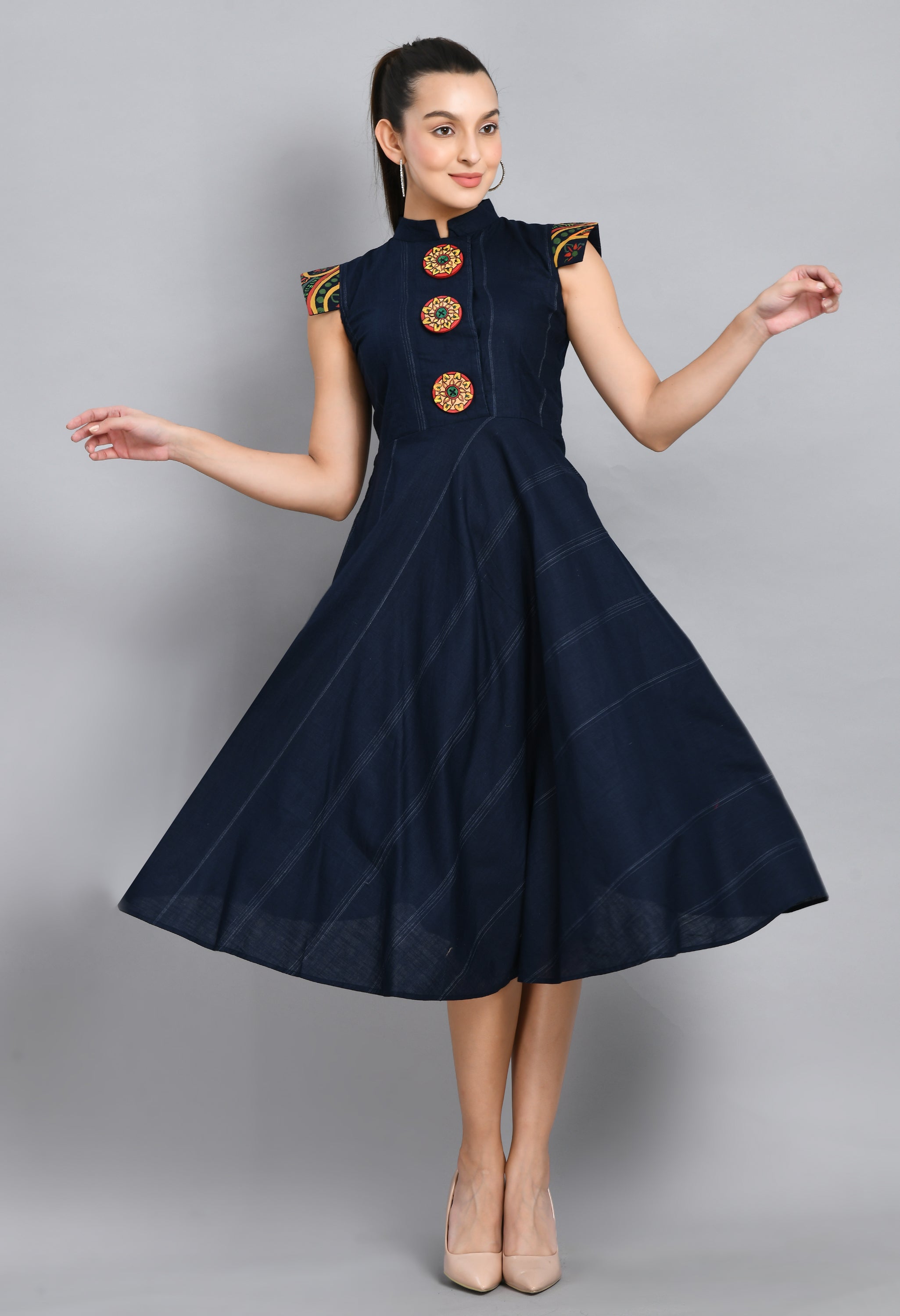 A beautiful blue linen dress featuring hand-painted sleeves and buttons, showcasing unique artistic designs.