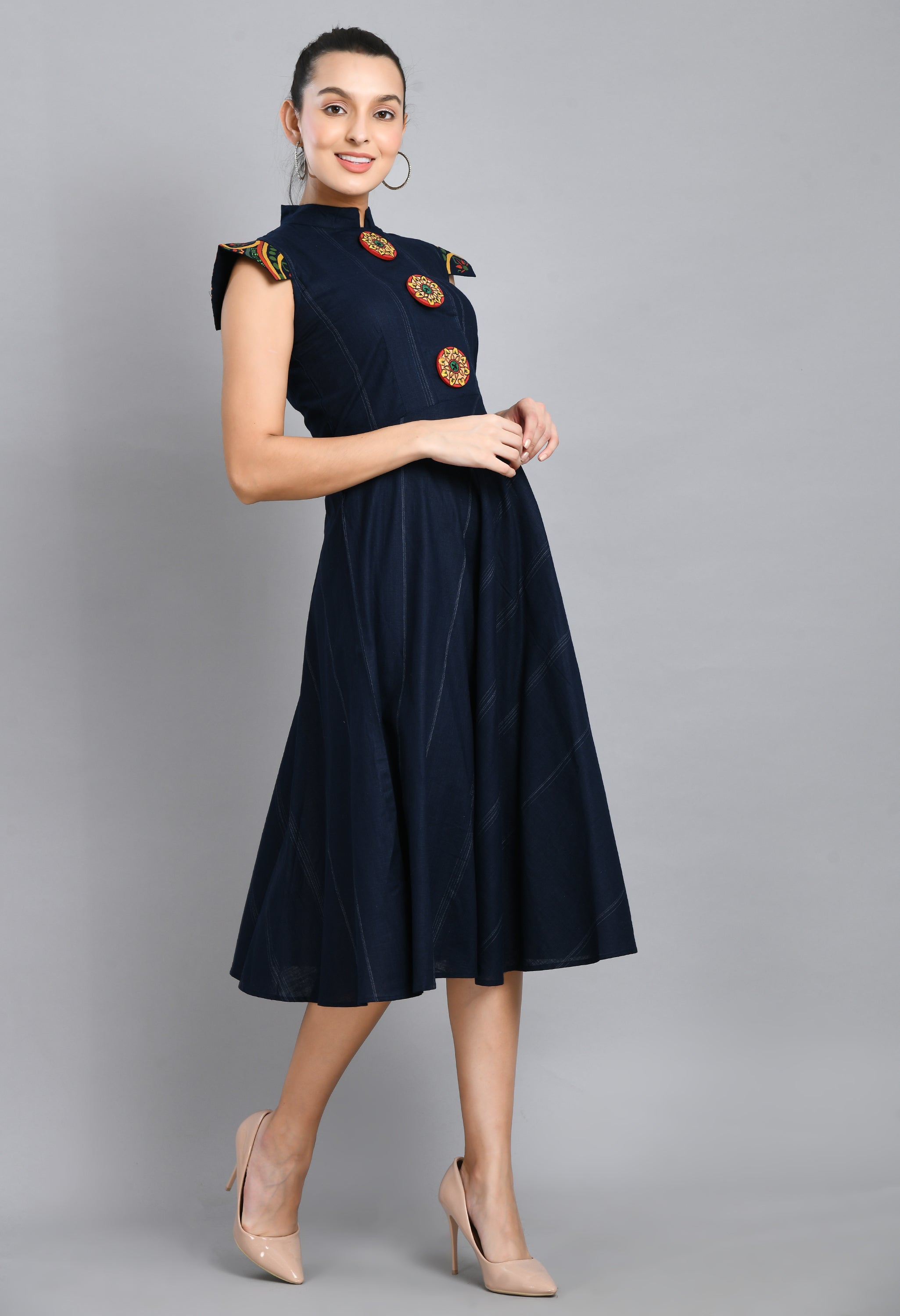 A beautiful blue linen dress featuring hand-painted sleeves and buttons, showcasing unique artistic designs.