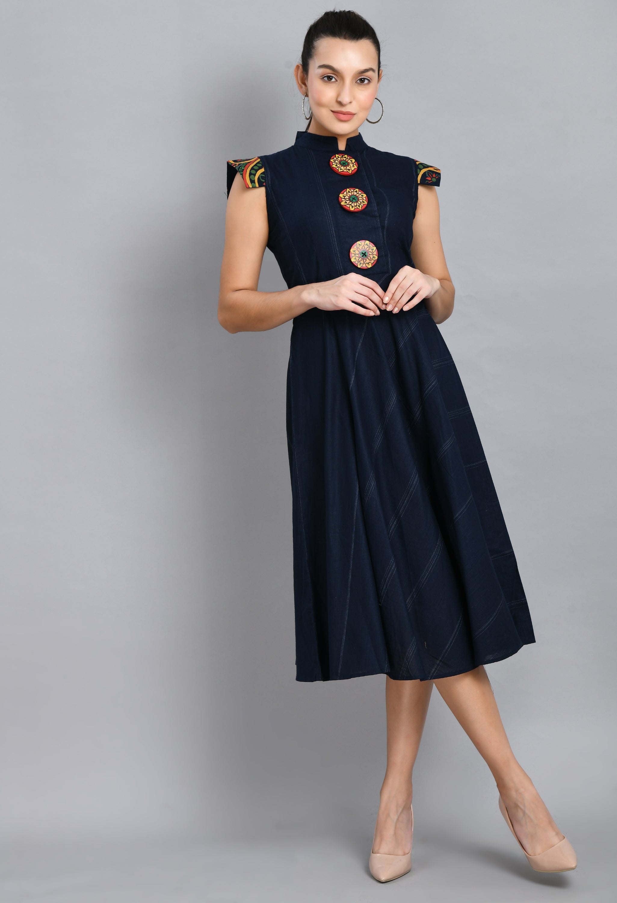 A beautiful blue linen dress featuring hand-painted sleeves and buttons, showcasing unique artistic designs.