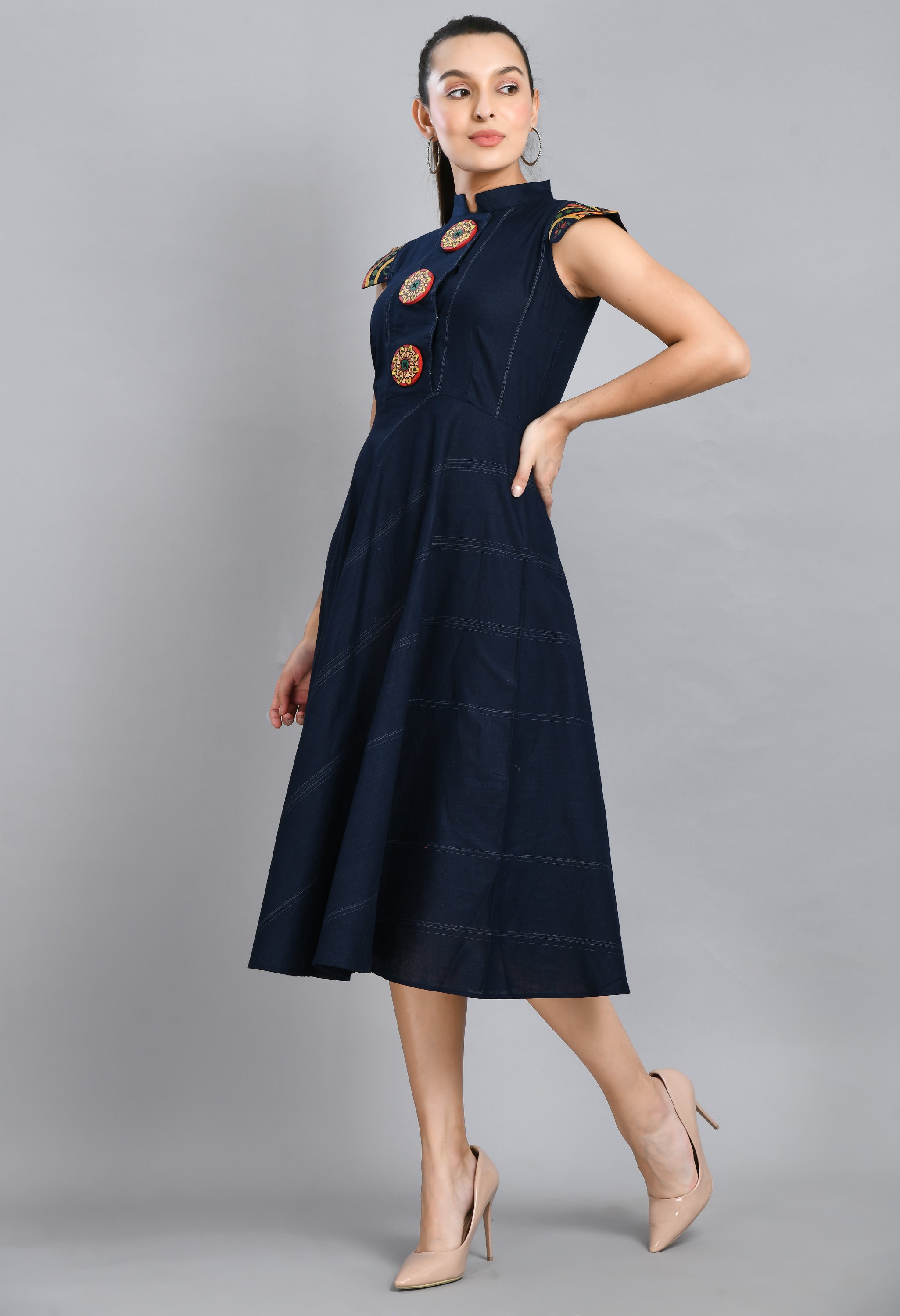A beautiful blue linen dress featuring hand-painted sleeves and buttons, showcasing unique artistic designs.